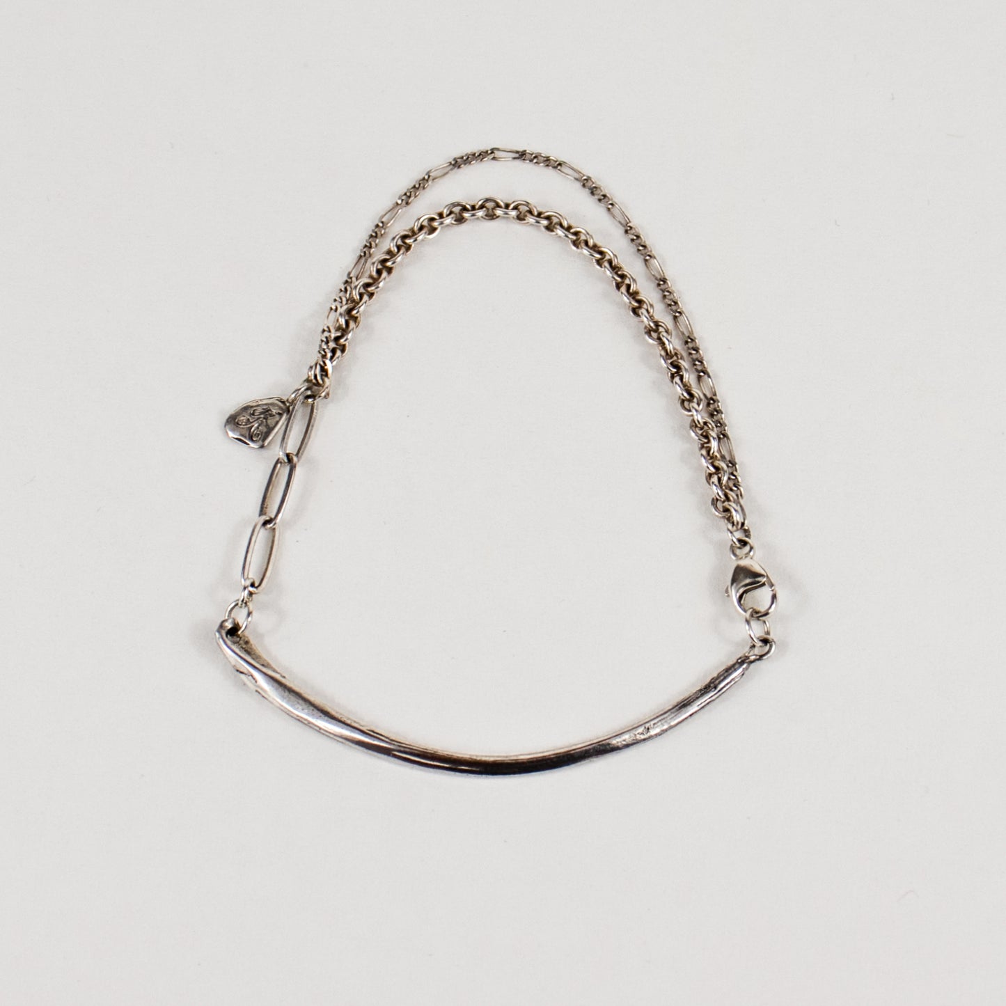 Arc charm measuring 2 inches in length available in reclaimed sterling silver or brass on a gold-filled and sterling mixed-chain bracelet handmade and finished in our Catskills store-studio