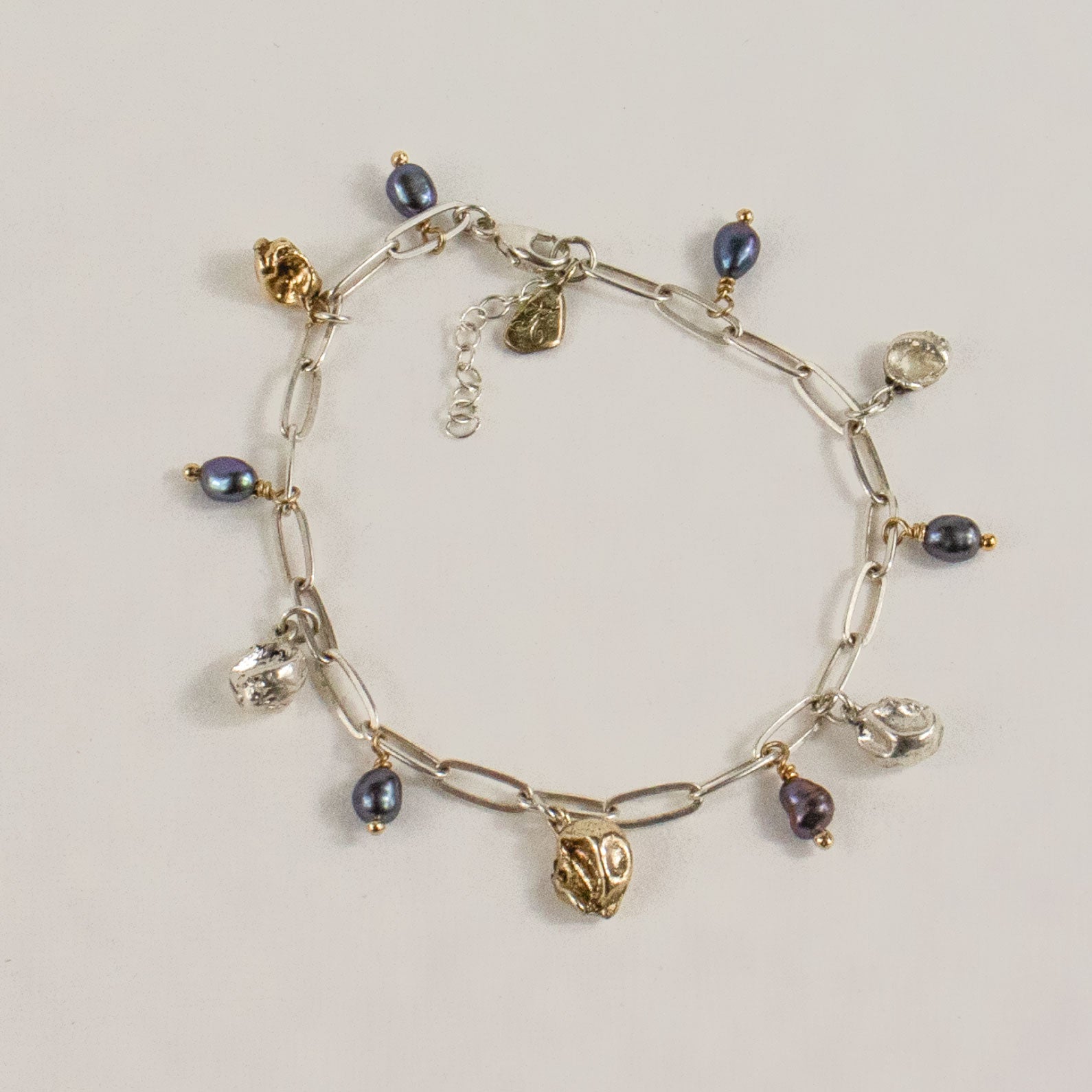 Reclaimed sterling silver and brass 5 mm seaweed pods beaded with six 4 mm black pearls on sterling chain 7 inches in diameter handmade and finished in our Catskills store-studio