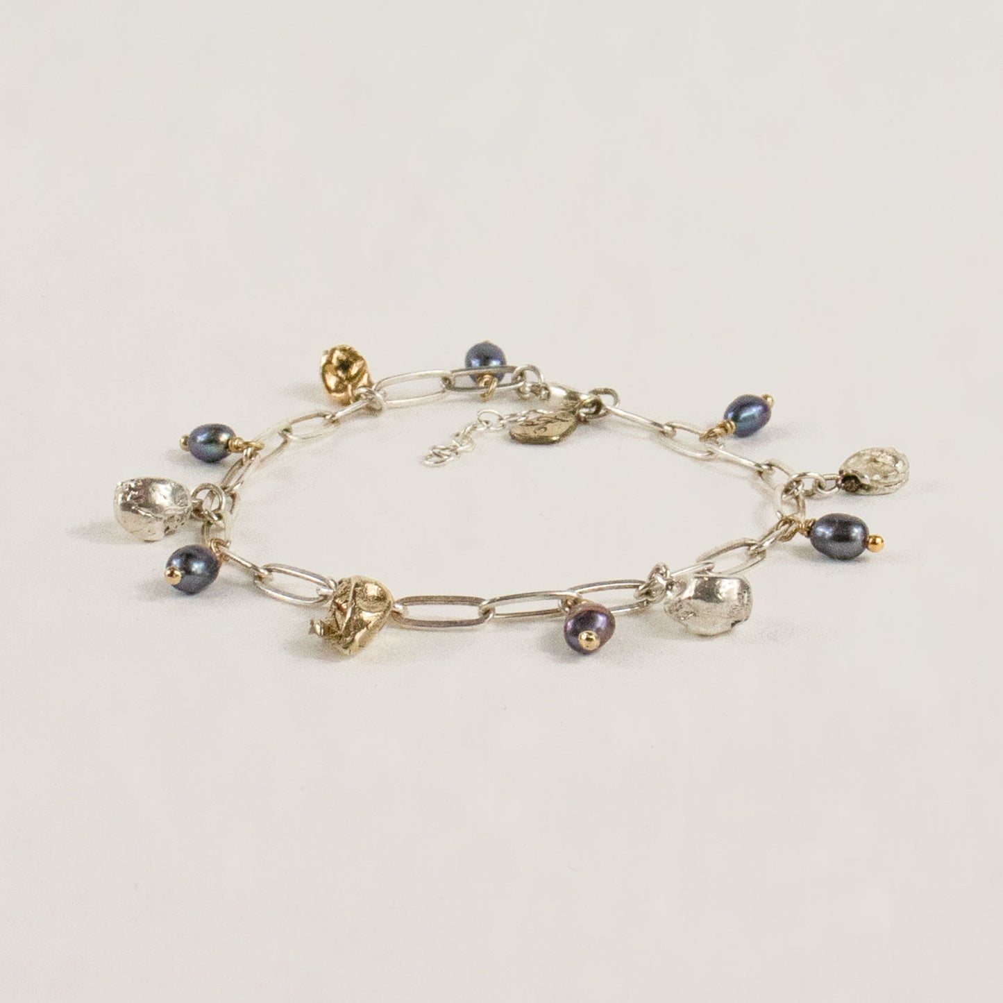 Reclaimed sterling silver and brass 5 mm seaweed pods beaded with six 4 mm black pearls on sterling chain 7 inches in diameter handmade and finished in our Catskills store-studio