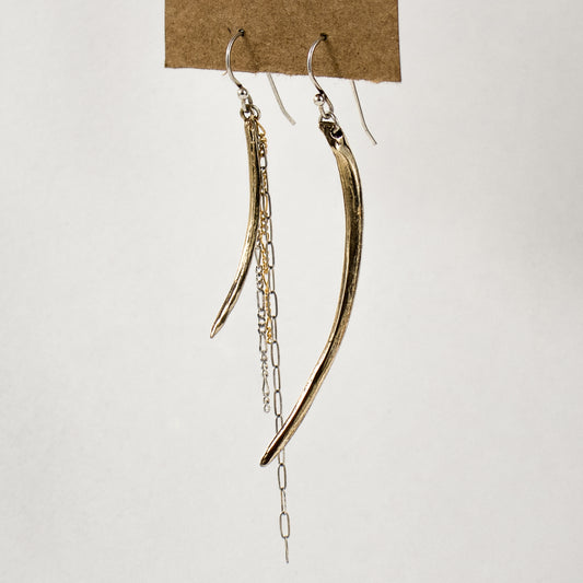 Asymmetrical arc charms measuring 1.5 and 2.25 inches each available in brass or sterling silver with sterling and gold-filled tassels dangling from sterling hooks handmade and finished in our Catskills store-studio