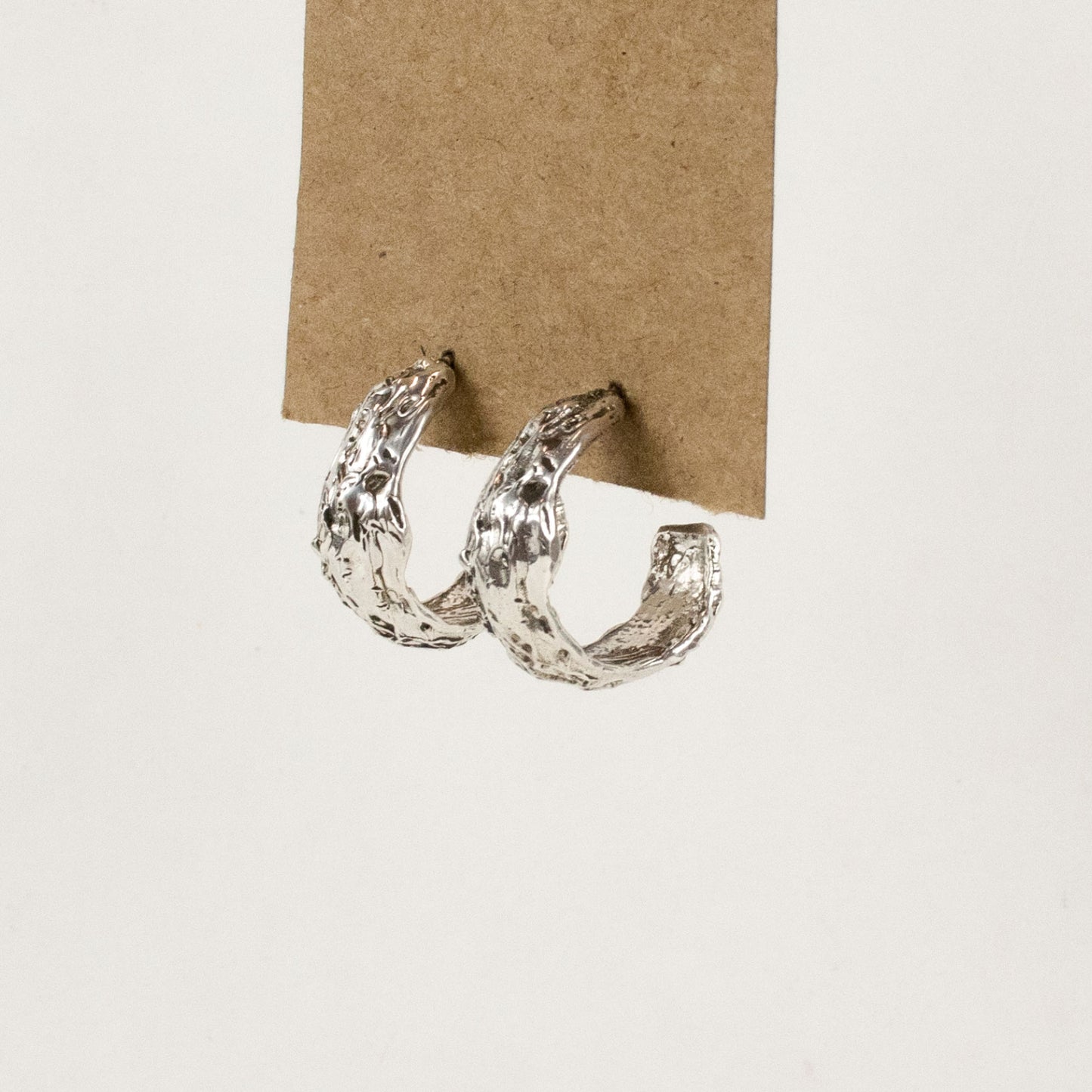 Textured hoop earring available in all sterling silver or brass with sterling post and backing, measuring 0.25 inch wide and 0.75 inch in diameter handmade and finished in our Catskills store-studio.