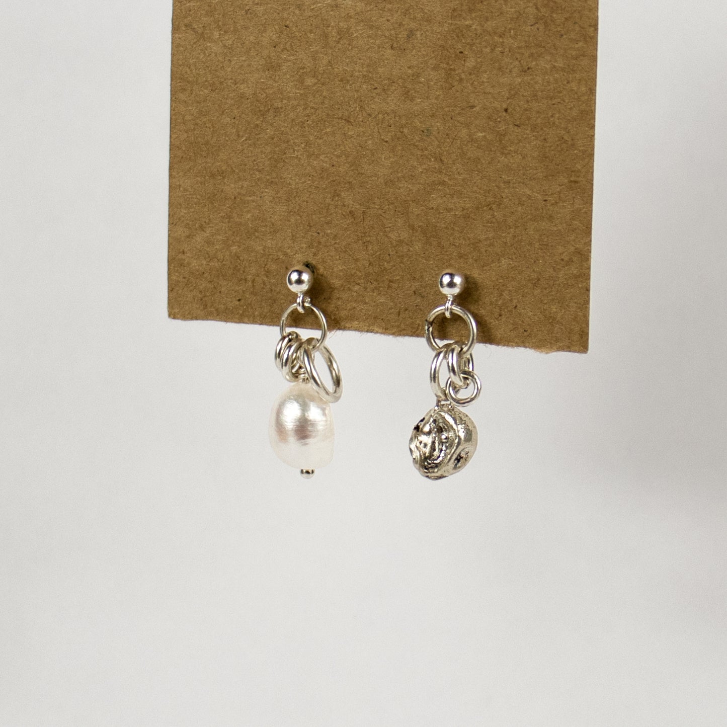Reclaimed sterling silver seaweed 7 mm pod and jump-ring asymmetrical earrings with 10 mm freshwater pearl on sterling studs handmade and finished in our Catskills store-studio.