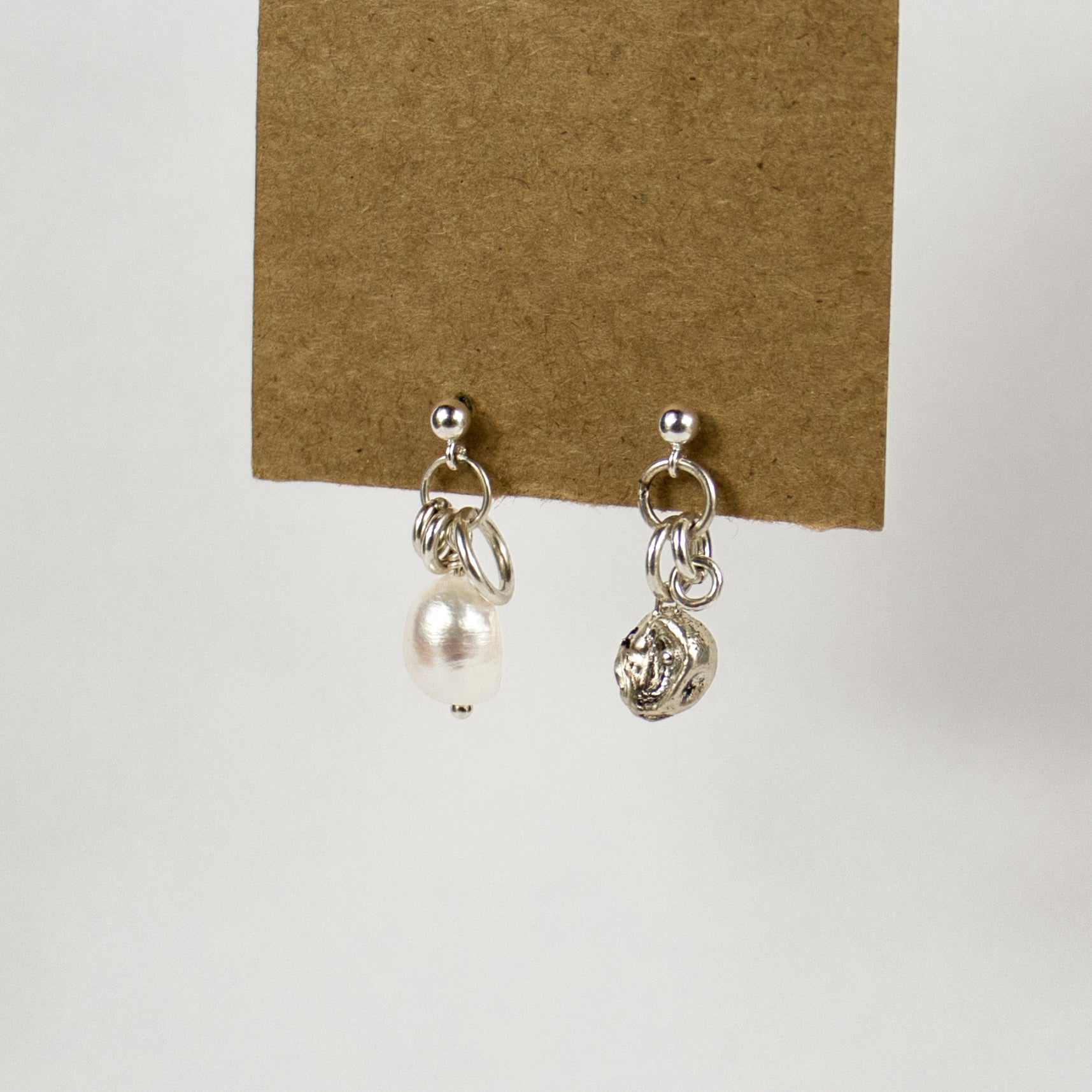 Reclaimed sterling silver seaweed 7 mm pod and jump-ring asymmetrical earrings with 10 mm freshwater pearl on sterling studs handmade and finished in our Catskills store-studio.