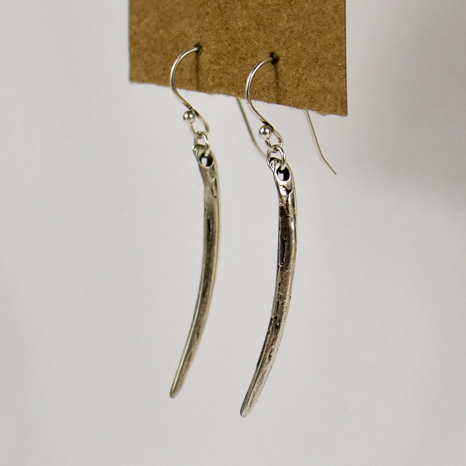 The fishbone is available in either solid reclaimed sterling silver or brass measuring 1.5 inches in length both dangling from sterling silver hooks and jump-rings.