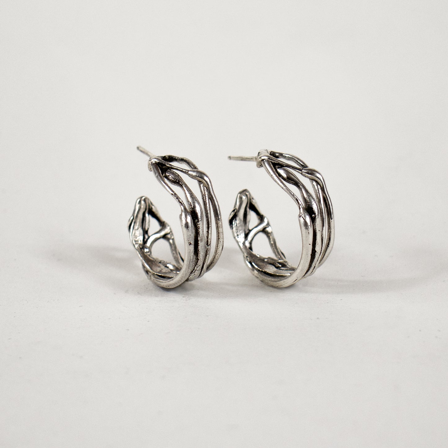 Melted wave hoop earrings available in all sterling silver or brass with sterling post and backings measuring 0.25 inch wide and 0.75 inch in diameter handmade and finished in our Catskills store-studio.