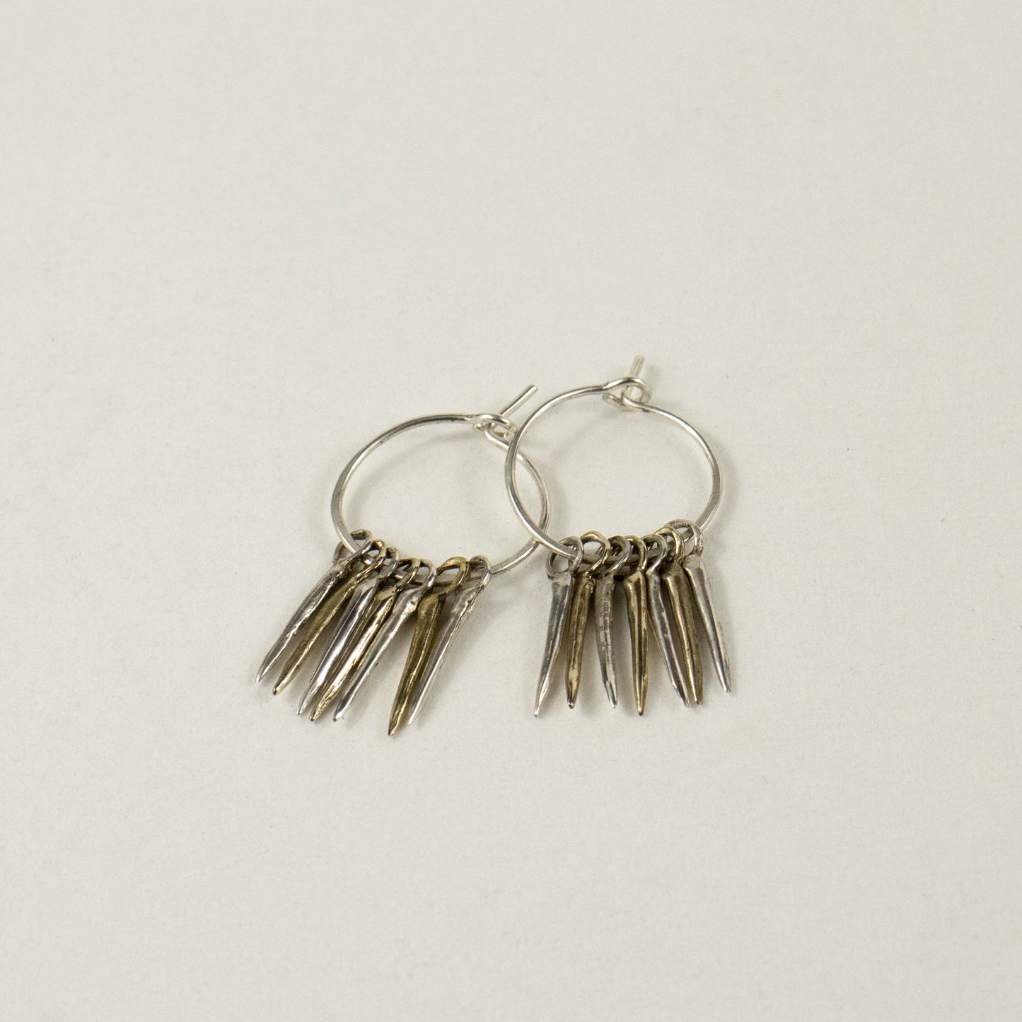 Four solid reclaimed sterling silver and three brass 0.5 inch snake-spikes on handmade sterling hoops handmade and finished in our Catskills store-studio and available as singles to mix-and-match