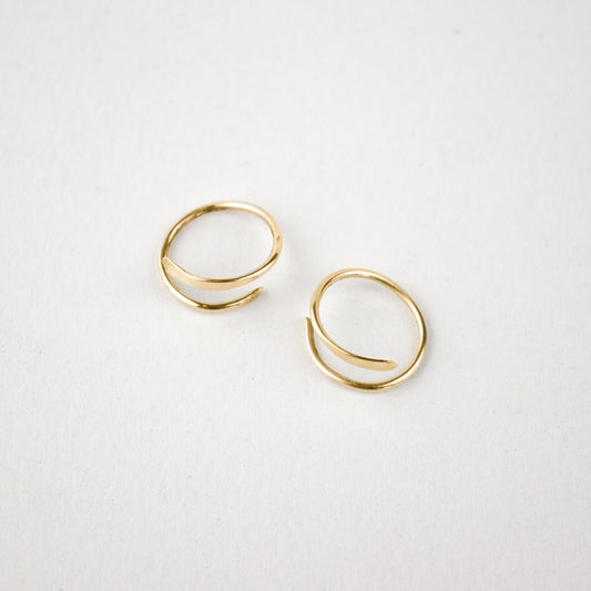 Solid reclaimed 10k gold spiral hoops 0.75 in diameter, hammer-finished in our Catskills store-studio, and available as singles to mix-and-match.