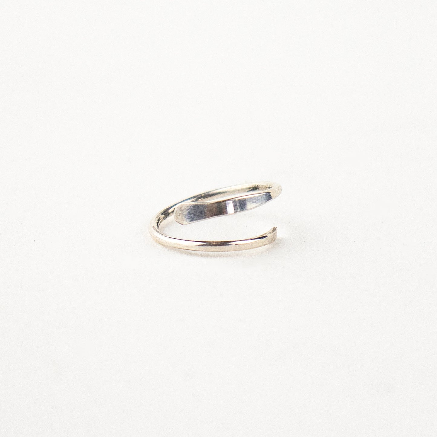 Reclaimed sterling silver hammer-finished spiral hoop earrings measuring 0.75" in diameter handmade and finished in our Catskills store-studio.