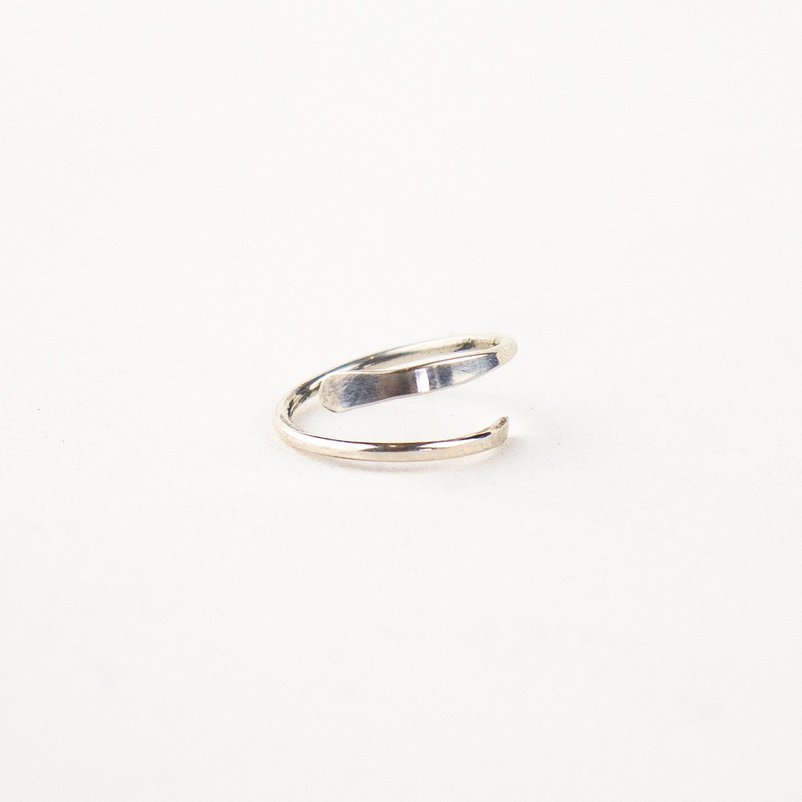 Reclaimed sterling silver hammer-finished spiral hoop earrings measuring 0.75" in diameter handmade and finished in our Catskills store-studio.