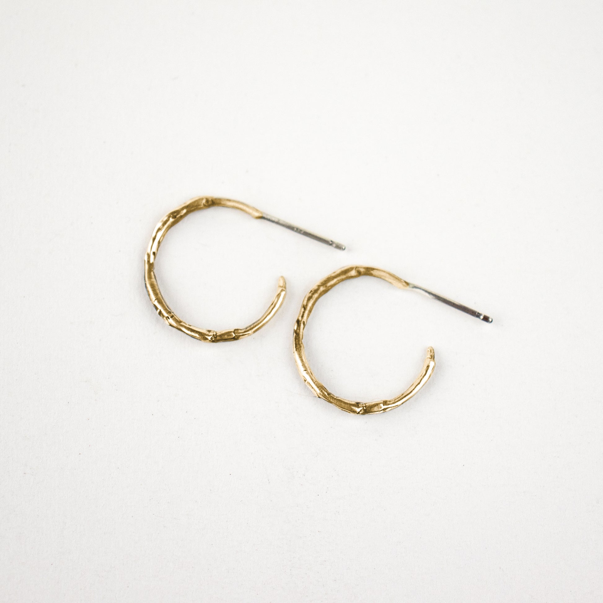 Solid reclaimed 10k gold small branch hoop earrings measuring 1 inch in diameter with sterling posts handmade and finished in our Catskills store-studio