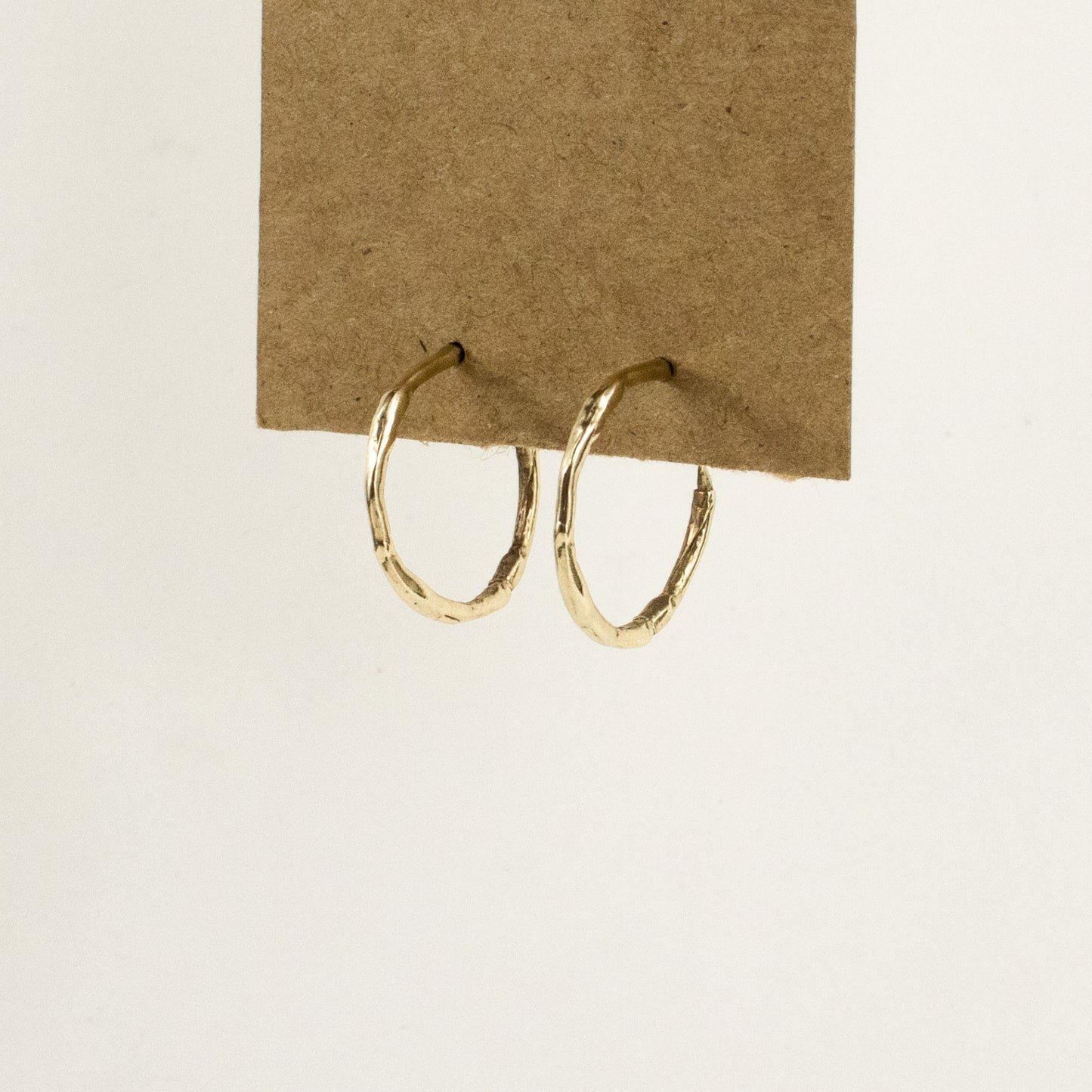 Solid reclaimed 10k gold small branch hoop earrings measuring 1 inch in diameter with sterling posts handmade and finished in our Catskills store-studio