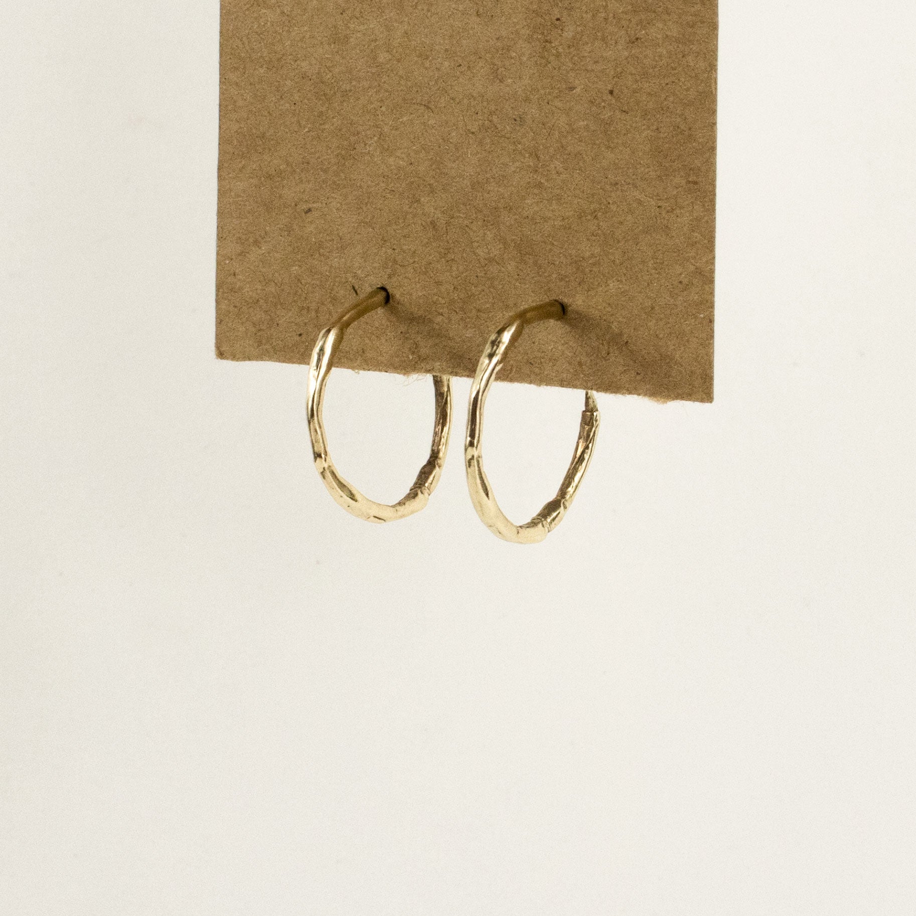 Solid reclaimed 10k gold small branch hoop earrings measuring 1 inch in diameter with sterling posts handmade and finished in our Catskills store-studio