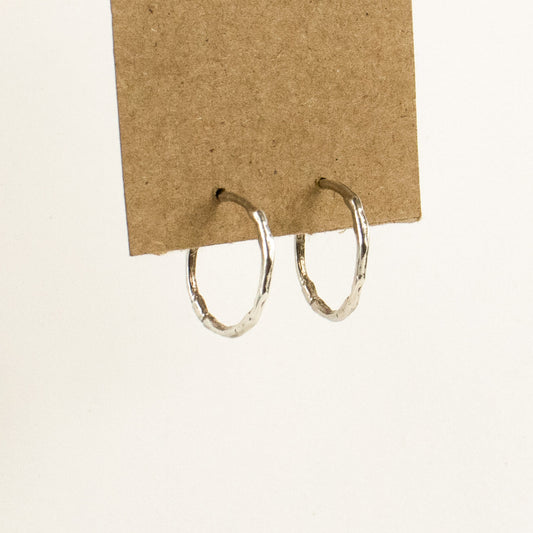 Solid reclaimed sterling silver small branch hoop earrings measuring 1 inch in diameter handmade and finished in our Catskills store-studio shown on model