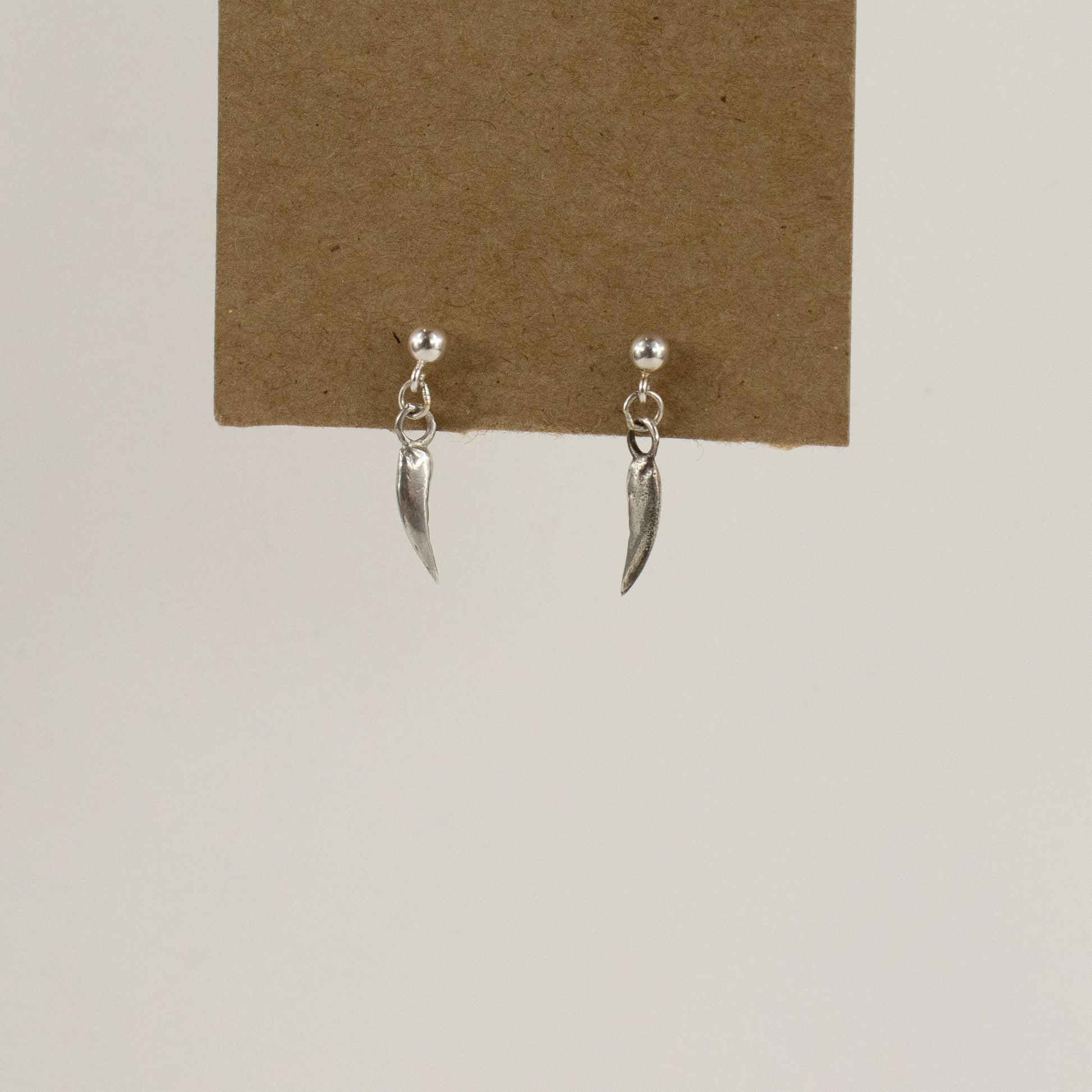 Solid reclaimed sterling silver dangling claw stud earrings handmade and finished in our Catskills store-studio and available as singles to mix-and-match