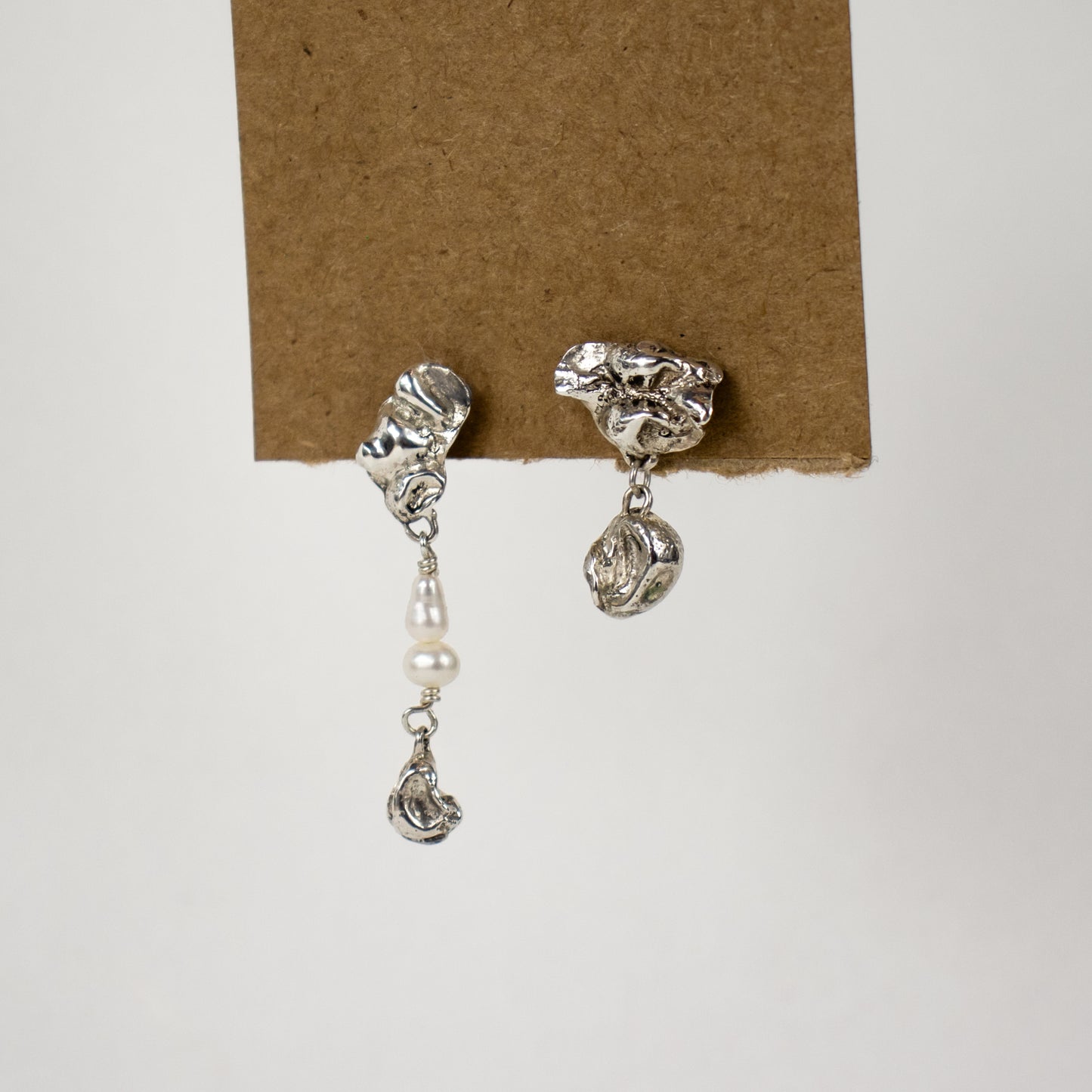 Reclaimed sterling silver asymmetrical seaweed pods dangling from sterling studs and beaded with freshwater pearls 1 and 1.5 inches each handmade and finished in our Catskills store-studio
