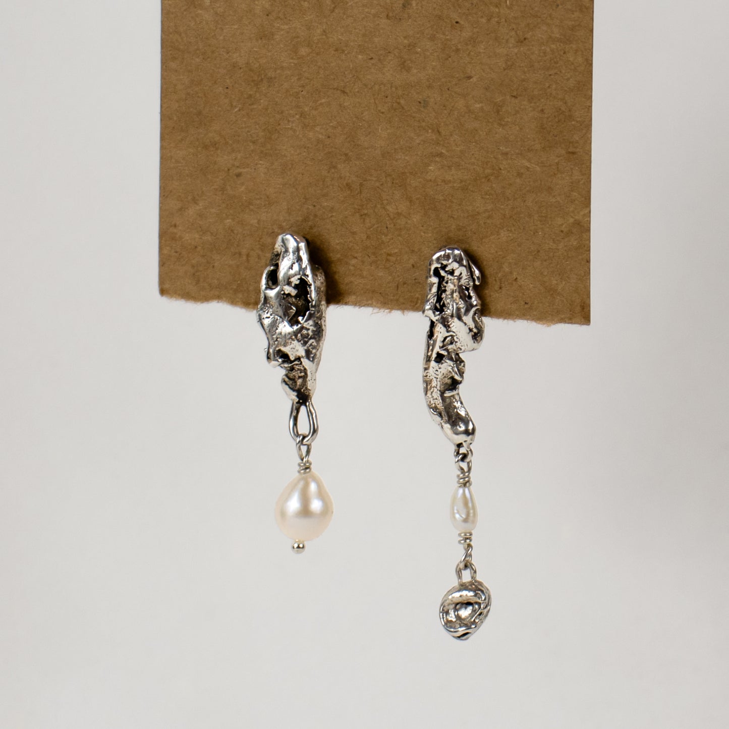 Asymmetrical reclaimed sculptural seaweed pods drop-beaded with freshwater pearls measuring 1.25 and 1.75 inches in length, available in sterling silver or brass handmade and finished in our Catskills store-studio.