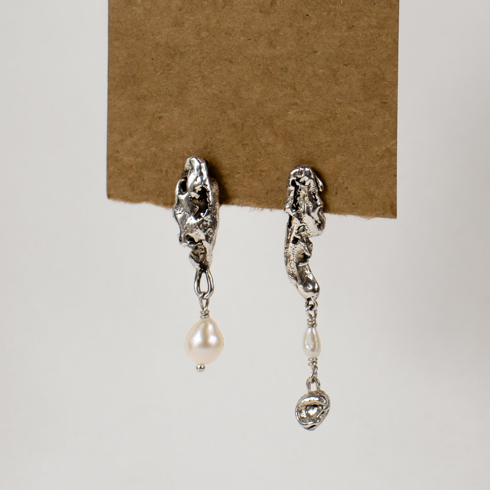 Asymmetrical reclaimed sculptural seaweed pods drop-beaded with freshwater pearls measuring 1.25 and 1.75 inches in length, available in sterling silver or brass handmade and finished in our Catskills store-studio.