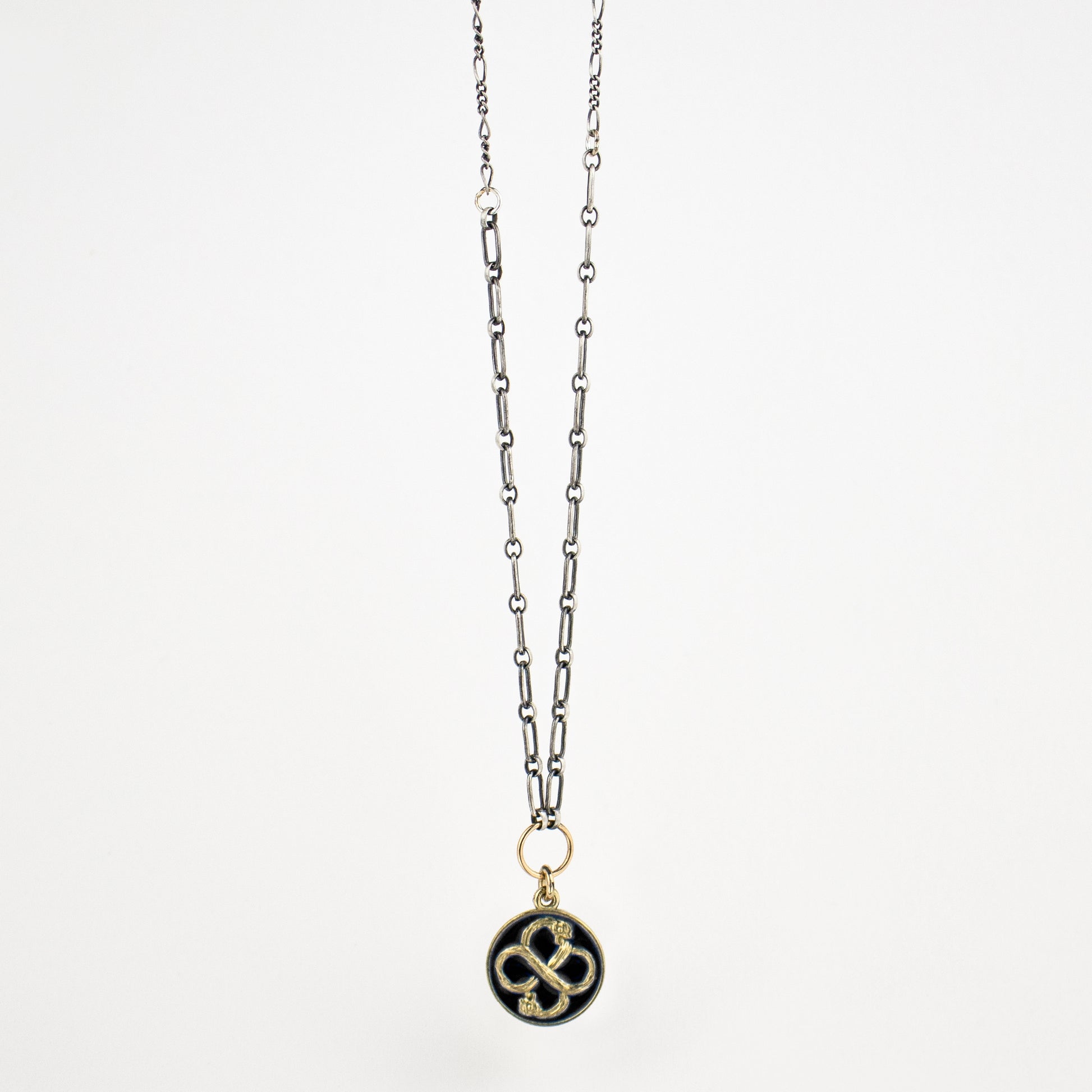 Enameled solid reclaimed 10k gold Serpent Infinity Knot charm on sterling mixed-chain adjustable 16 - 18 inches with charm 15 mm in diameter in your choice of black or lemon enamel. Serpent symbolism can represent life and healing, and the infinite knot simplicity and balance