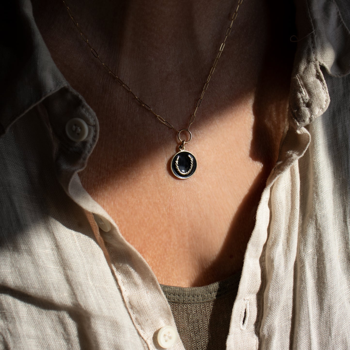 Solid reclaimed 10k gold Roped Horseshoe charm 15 mm in diameter with your choice of black or lemon enamel on gold-filled fine paperclip chain adjustable 16 - 18 inches handmade and finished in our Catskills store-studio. Upright, the symbol serves as a receptacle for good luck as well as protection for its owner.