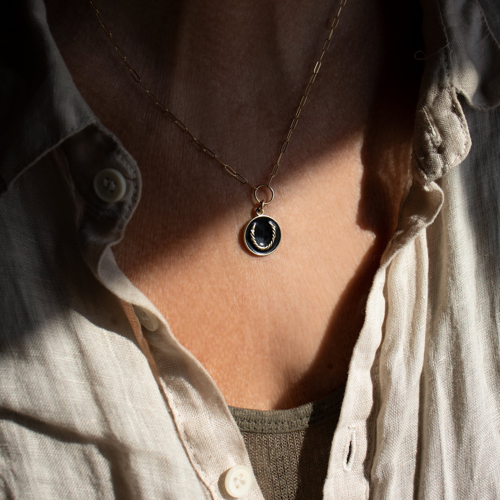 Solid reclaimed 10k gold Roped Horseshoe charm 15 mm in diameter with your choice of black or lemon enamel on gold-filled fine paperclip chain adjustable 16 - 18 inches handmade and finished in our Catskills store-studio. Upright, the symbol serves as a receptacle for good luck as well as protection for its owner.