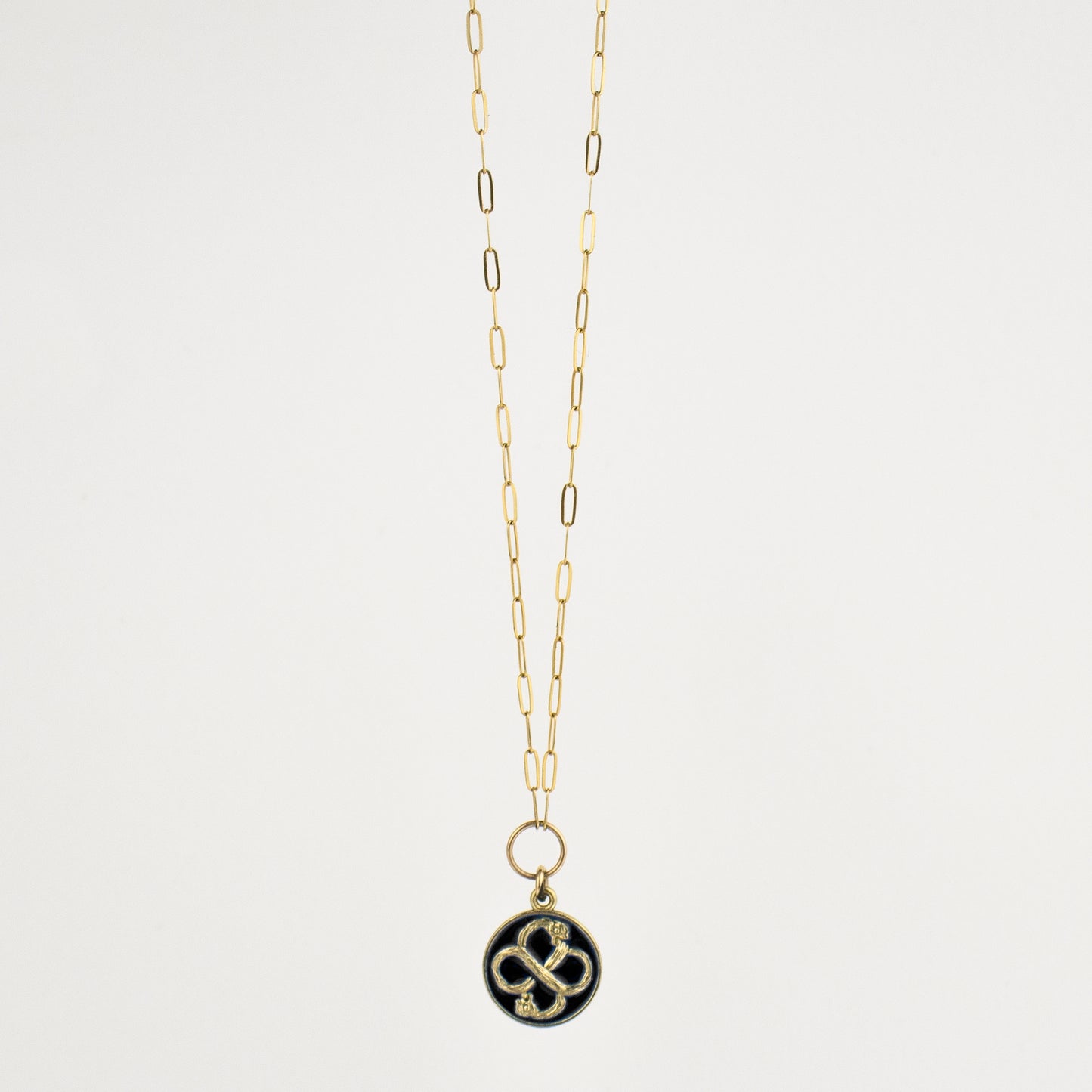 Solid reclaimed 10k gold Serpent Infinity Knot charm 15 mm in diameter with your choice of black or lemon enamel on gold-filled fine paperclip chain adjustable 16 - 18 inches handmade and finished in our Catskills store-studio. Serpent symbolism can represent life and healing, and the infinite knot simplicity and balance.