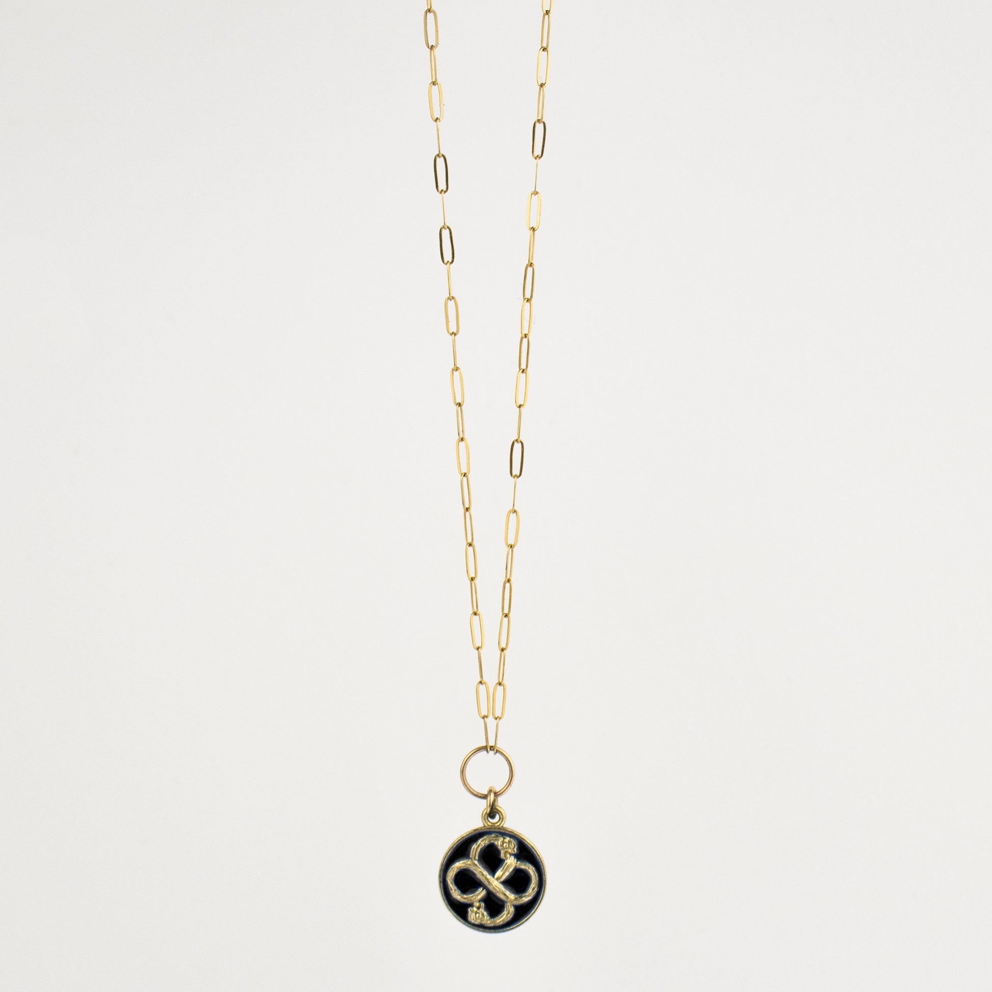 Solid reclaimed 10k gold Serpent Infinity Knot charm 15 mm in diameter with your choice of black or lemon enamel on gold-filled fine paperclip chain adjustable 16 - 18 inches handmade and finished in our Catskills store-studio. Serpent symbolism can represent life and healing, and the infinite knot simplicity and balance.