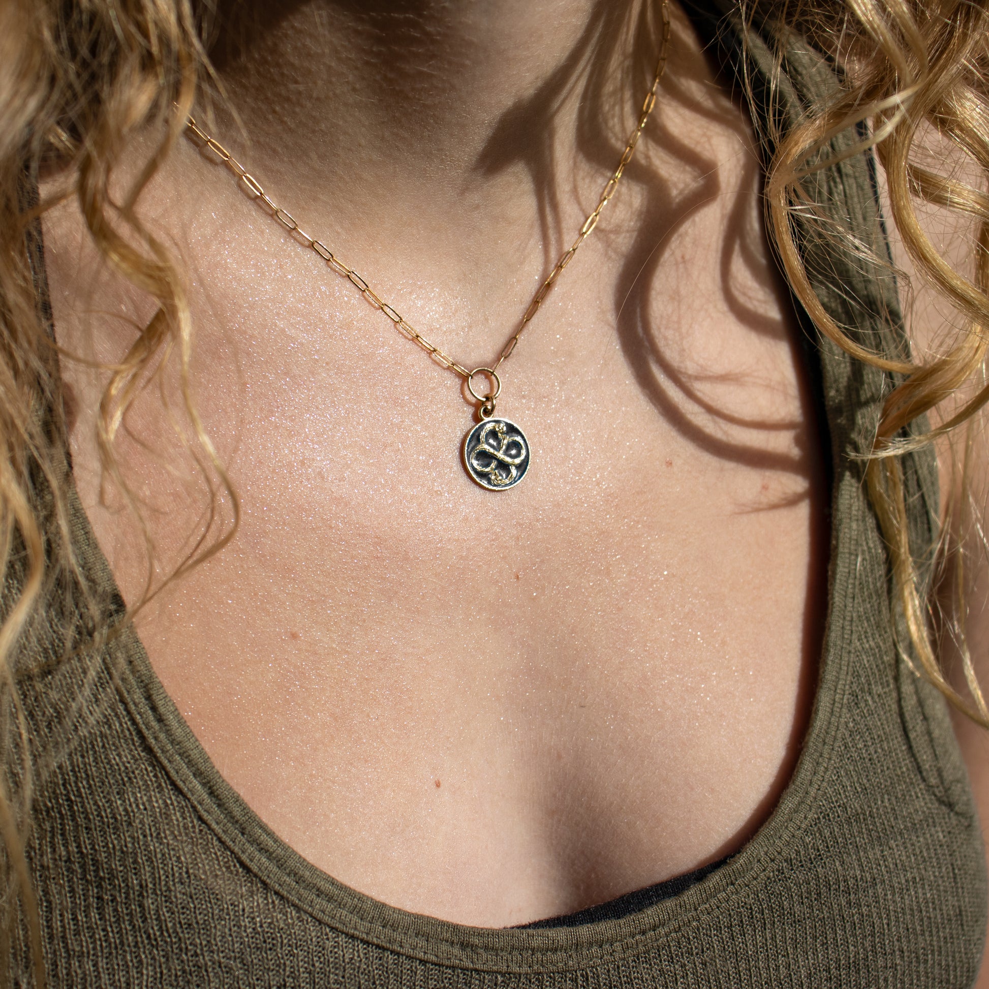 Solid reclaimed 10k gold Serpent Infinity Knot charm 15 mm in diameter with your choice of black or lemon enamel on gold-filled fine paperclip chain adjustable 16 - 18 inches handmade and finished in our Catskills store-studio. Serpent symbolism can represent life and healing, and the infinite knot simplicity and balance.