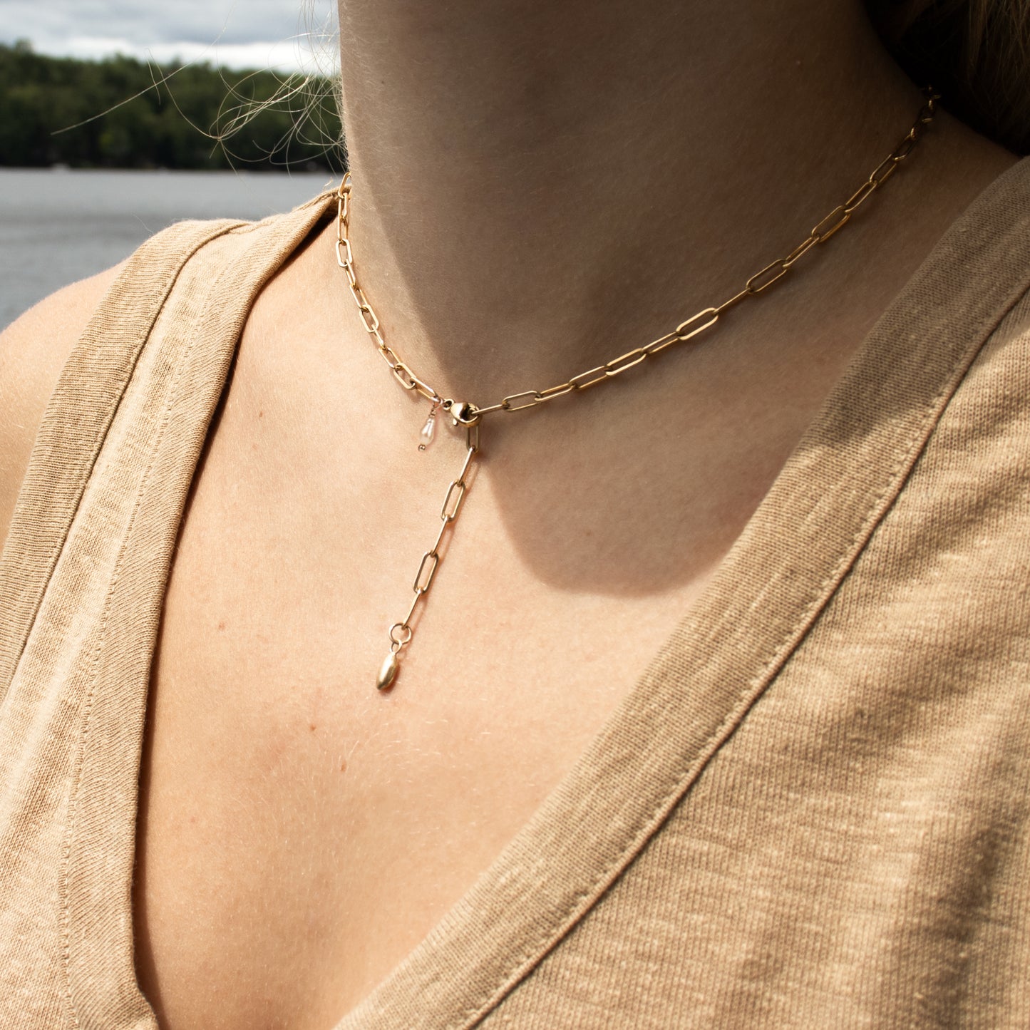 Reclaimed 10k gold seed with a freshwater pearl on a gold-filled paperclip chain choker with a sterling signature Kria tag and adjustable 14 - 18 inches handmade and finished in our Catskills store-studio shown on model.