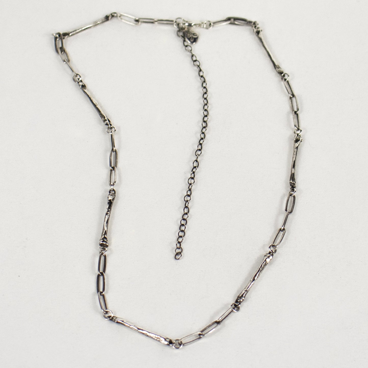 Sterling silver paperclip chain with eight evenly spaced solid reclaimed sterling silver coyote paw bones 0.75 inches each with sterling signature Kria tag and adjustable 14 - 18 inches handmade and finished in our Catskills store-studio.