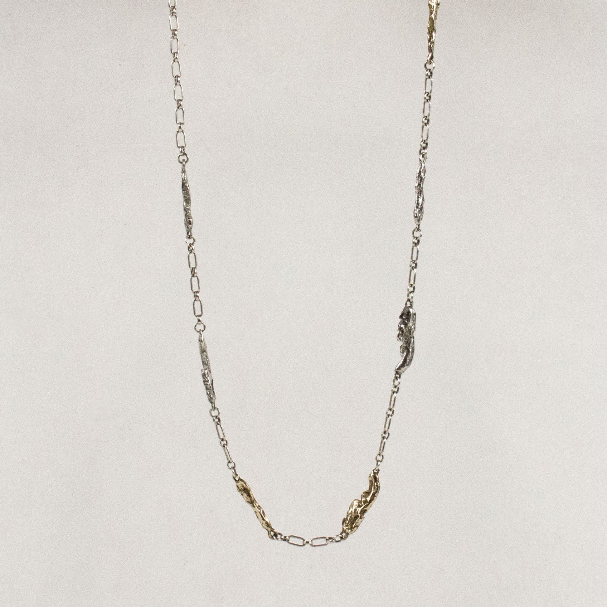 Four sterling silver and three brass seaweed pieces measuring 1 inch in length each on sterling chain handmade and finished in our Catskills store-studio
