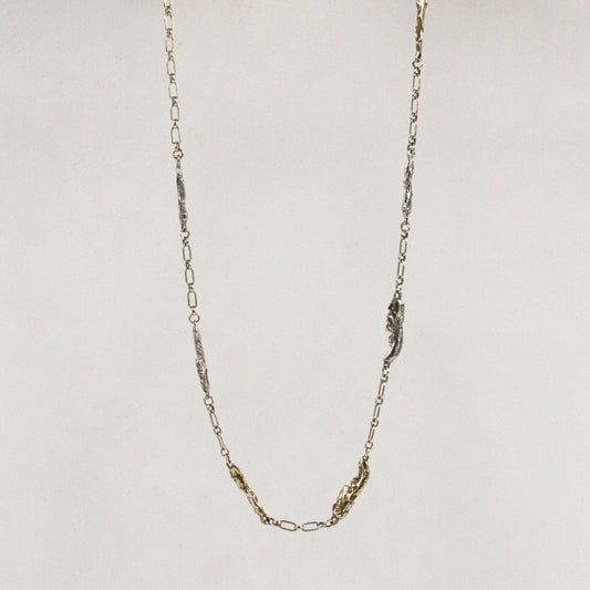 Four sterling silver and three brass seaweed pieces measuring 1 inch in length each on sterling chain handmade and finished in our Catskills store-studio