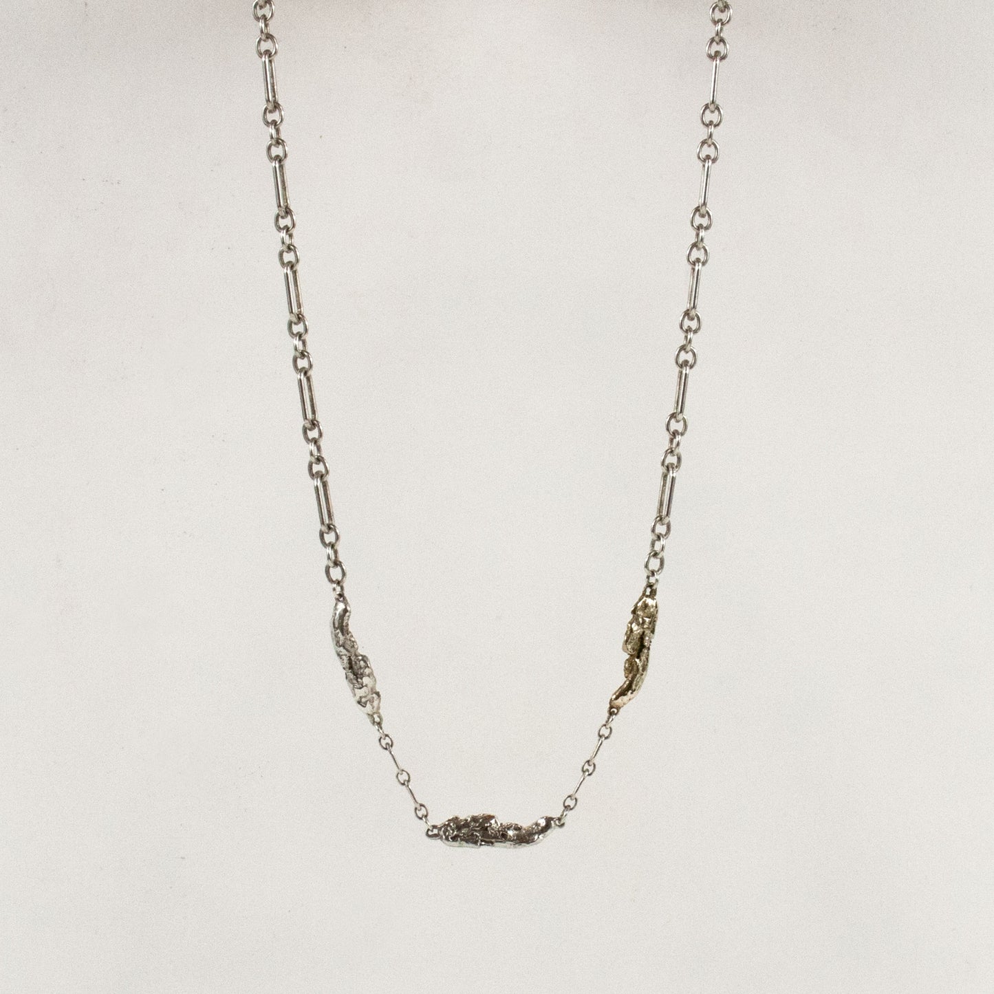 Two sterling silver and one brass seaweed piece measuring 1 inch in length each on sterling chain adjustable from 16 to 18 inches handmade and finished in our Catskills store-studio