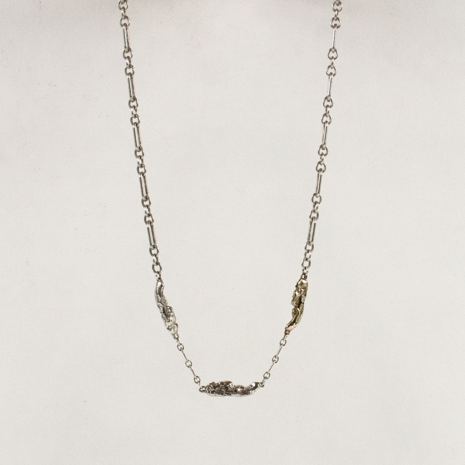 Two sterling silver and one brass seaweed piece measuring 1 inch in length each on sterling chain adjustable from 16 to 18 inches handmade and finished in our Catskills store-studio