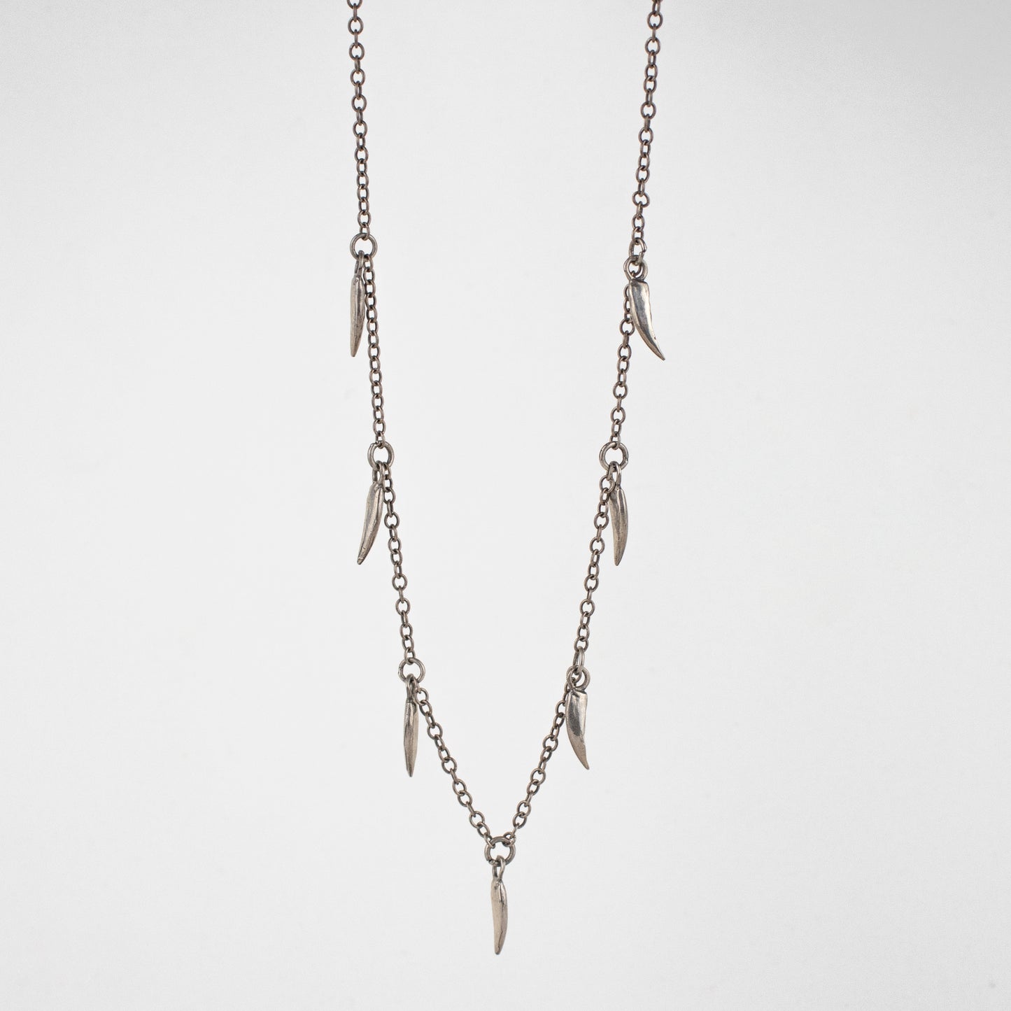 Seven solid reclaimed sterling silver muskrat claw charms on sterling chain adjustable 16 - 20 inches handmade and finished in our Catskills store-studio.