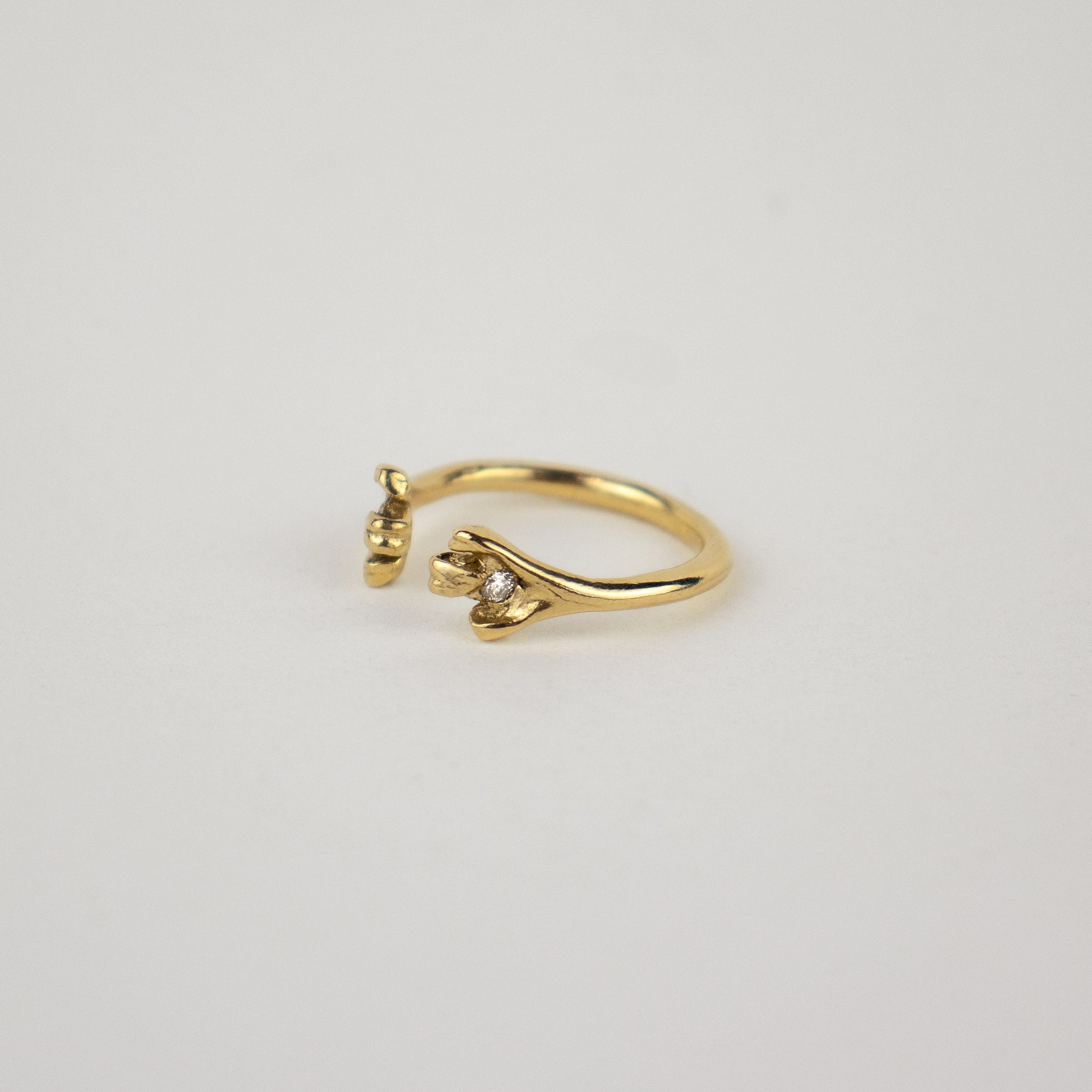 Solid reclaimed 14k gold femur ring set with two 2mm diamonds and adjustable for ring sizes 5 to 6.5 made-to-order and finished in our Catskills store-studio.