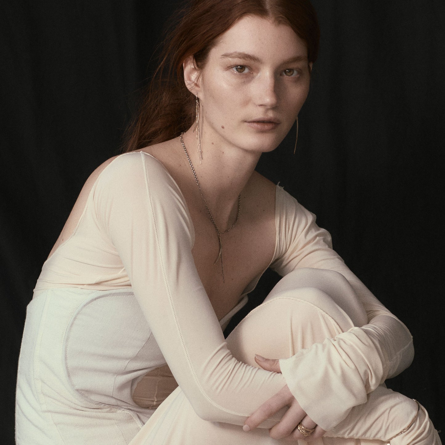 Asymmetrical arc charms measuring 1.5 and 2.25 inches each available in brass or sterling silver with sterling and gold-filled tassels dangling from sterling hooks handmade and finished in our Catskills store-studio