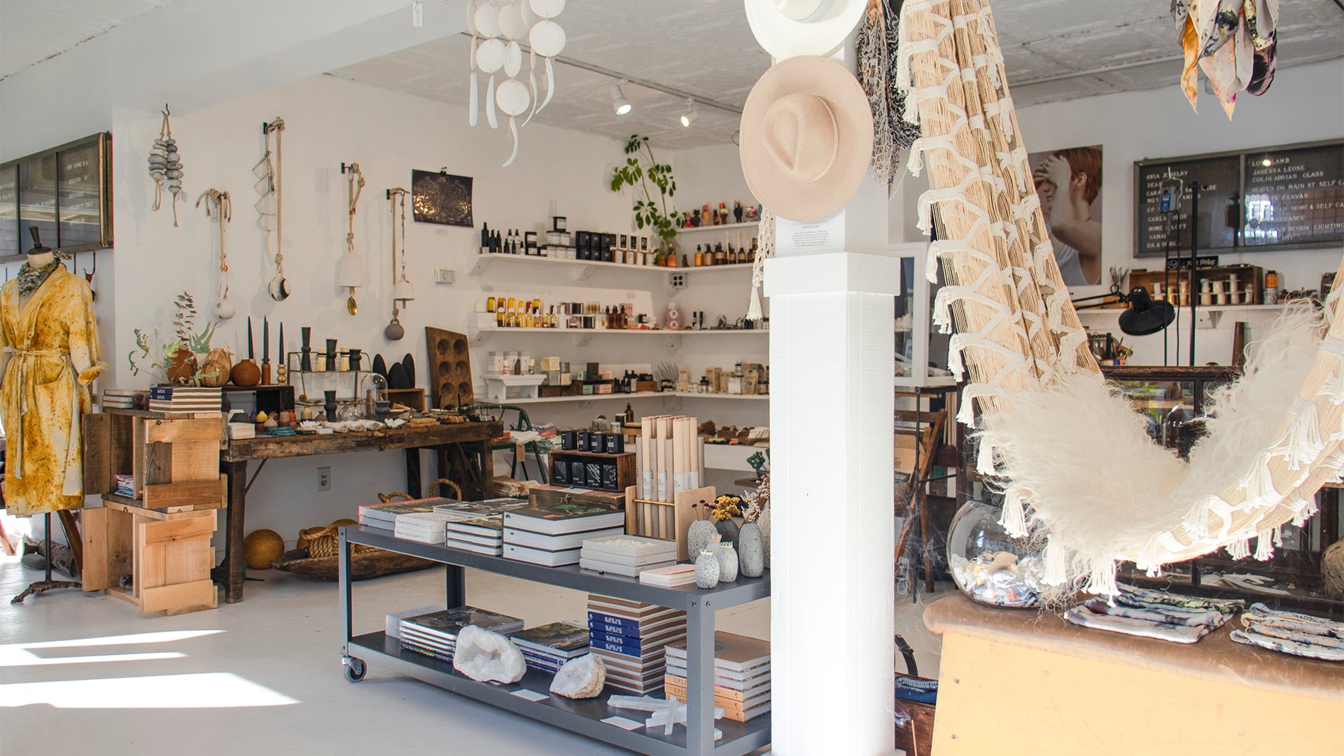 Interior image of the Kria World retail store which is both a jewelry studio and a lifestyle store with a curated menagerie of ceramics, glassware, objet d’art, vinyl records, books, fine art, apparel, and an extensive selection of self-care and wellness products all housed in a 100 year-old theater on Margaretville, New York’s historic Catskill Mountains main street.