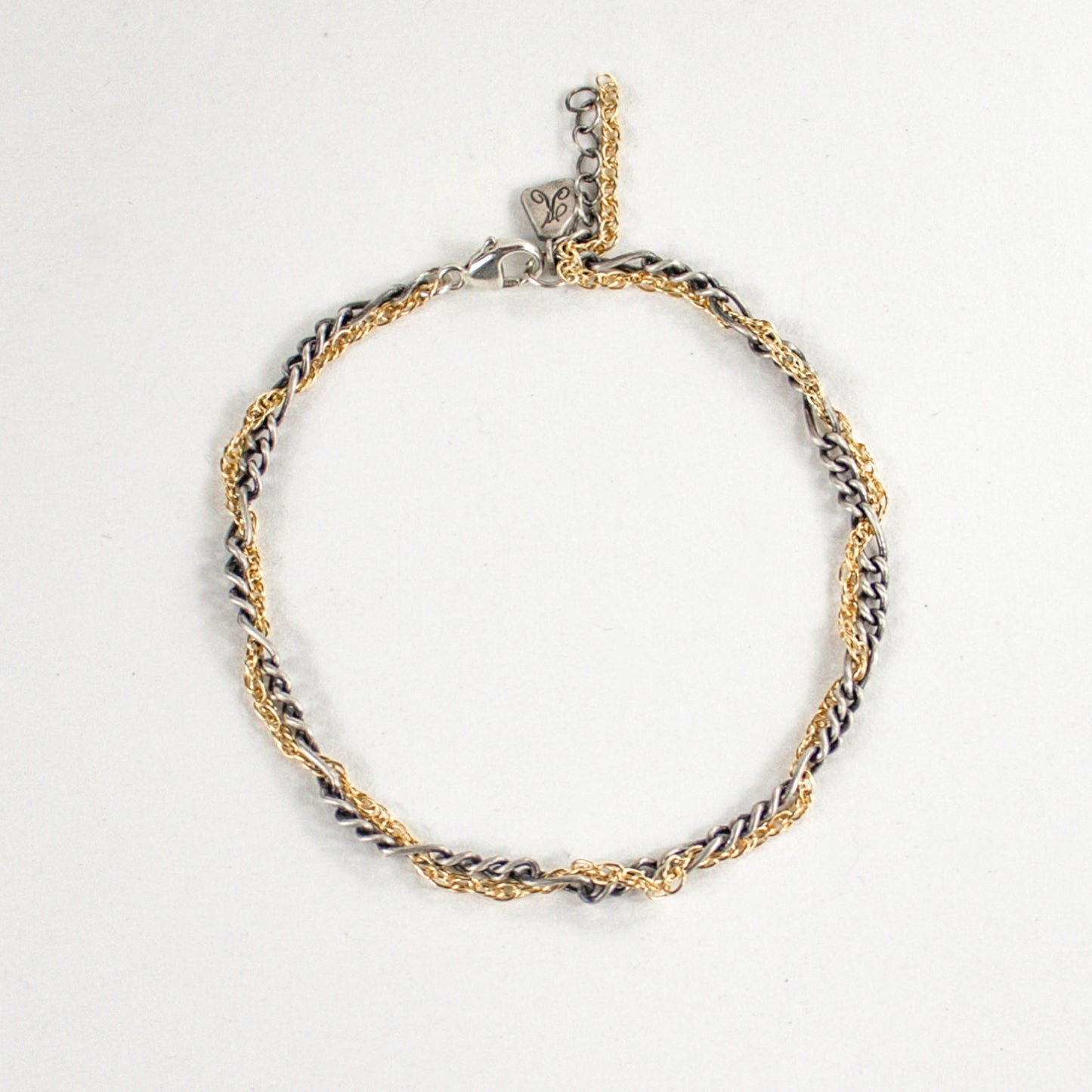 Hand-threaded sterling silver and gold-filled mixed-chain bracelet 7 inches in diameter with our signature sterling silver Kria tag