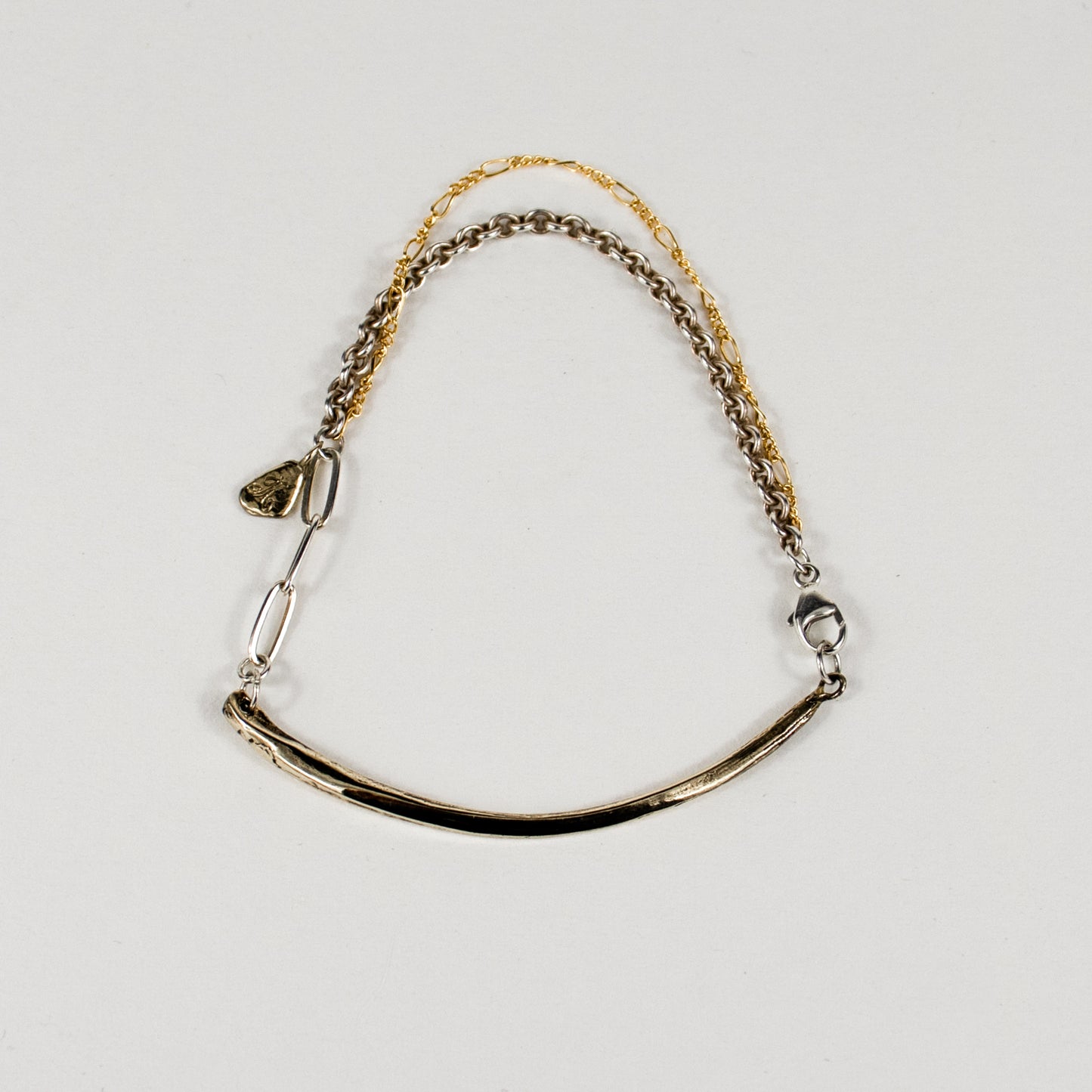 Arc charm measuring 2 inches in length and available in all reclaimed sterling silver or brass with gold-filled and sterling mixed-chain as a bracelet handmade and finished in our Catskills store-studio.