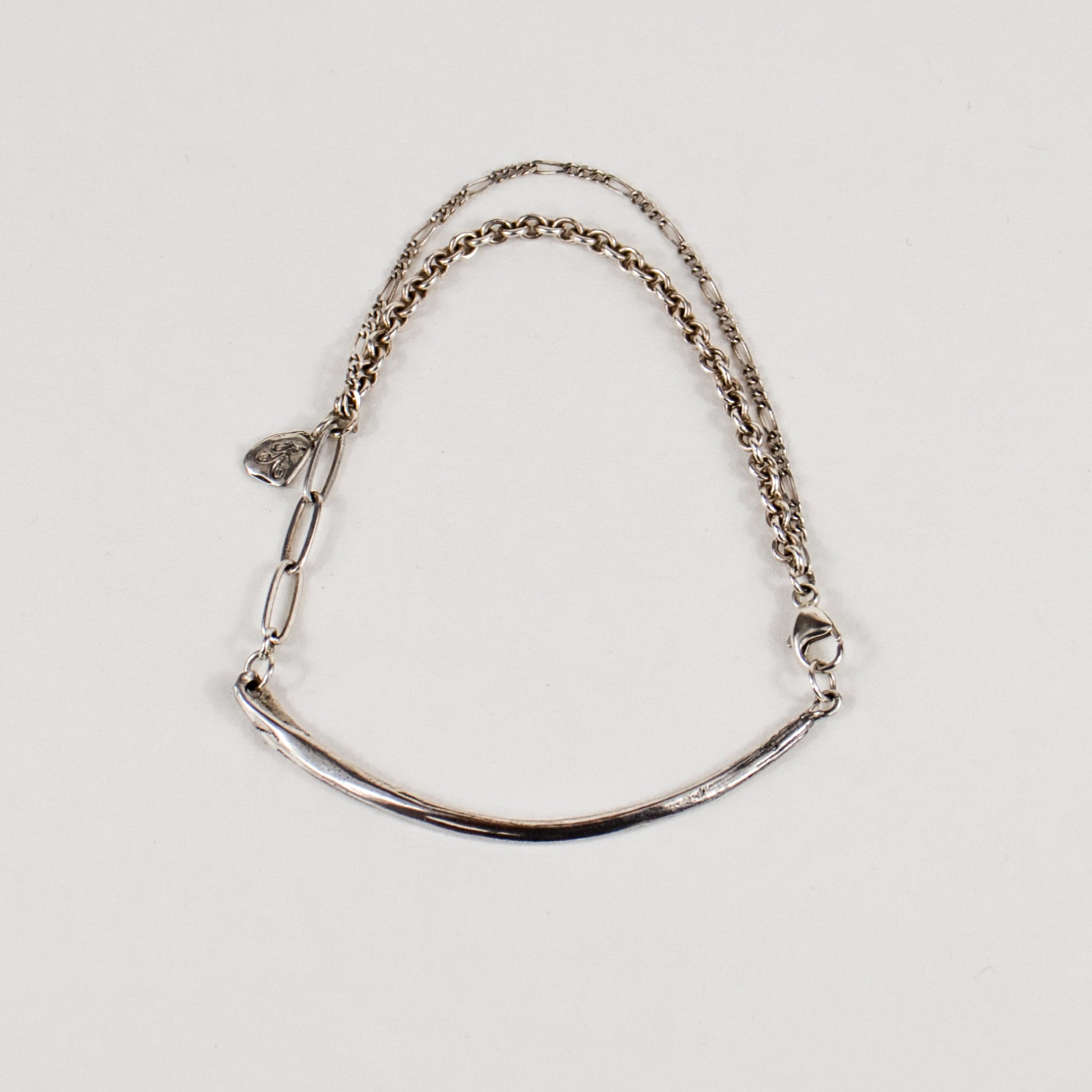 Arc charm measuring 2 inches in length and available in all reclaimed sterling silver or brass with gold-filled and sterling mixed-chain as a bracelet handmade and finished in our Catskills store-studio.