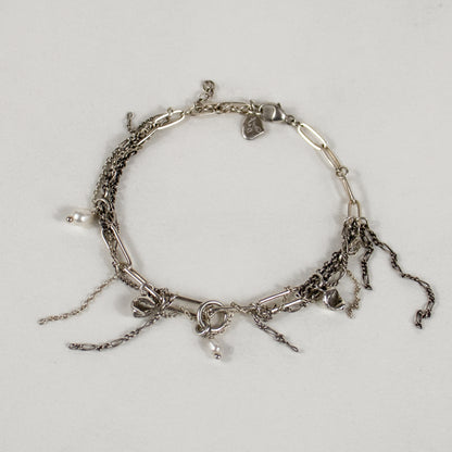 Sterling silver seaweed pods, tangled silver mixed-chain, and freshwater pearls on sterling paperclip-chain bracelet.
