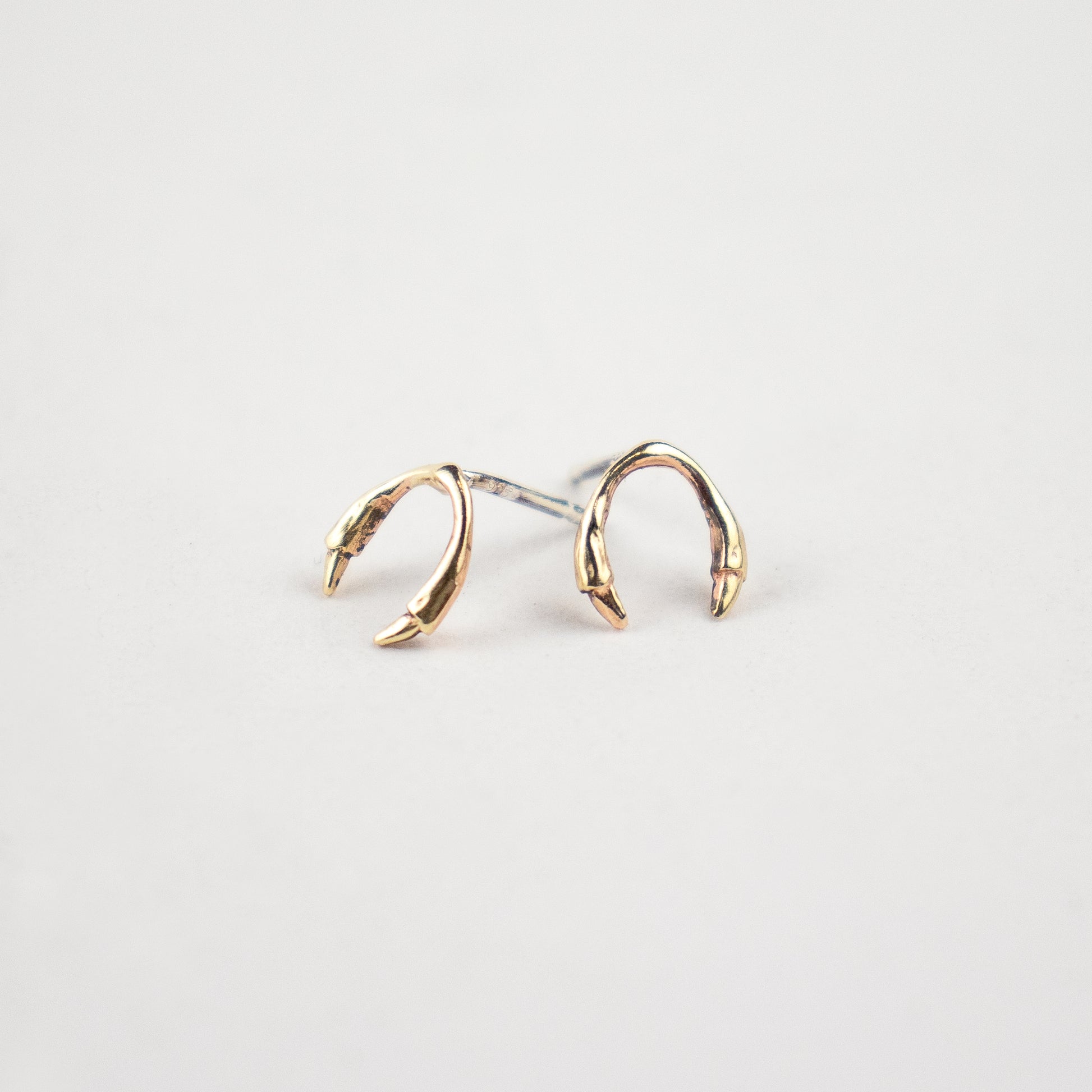 Solid reclaimed 10k gold branch horseshoe stud earrings on sterling silver posts handmade and finished in our Catskills store-studio.