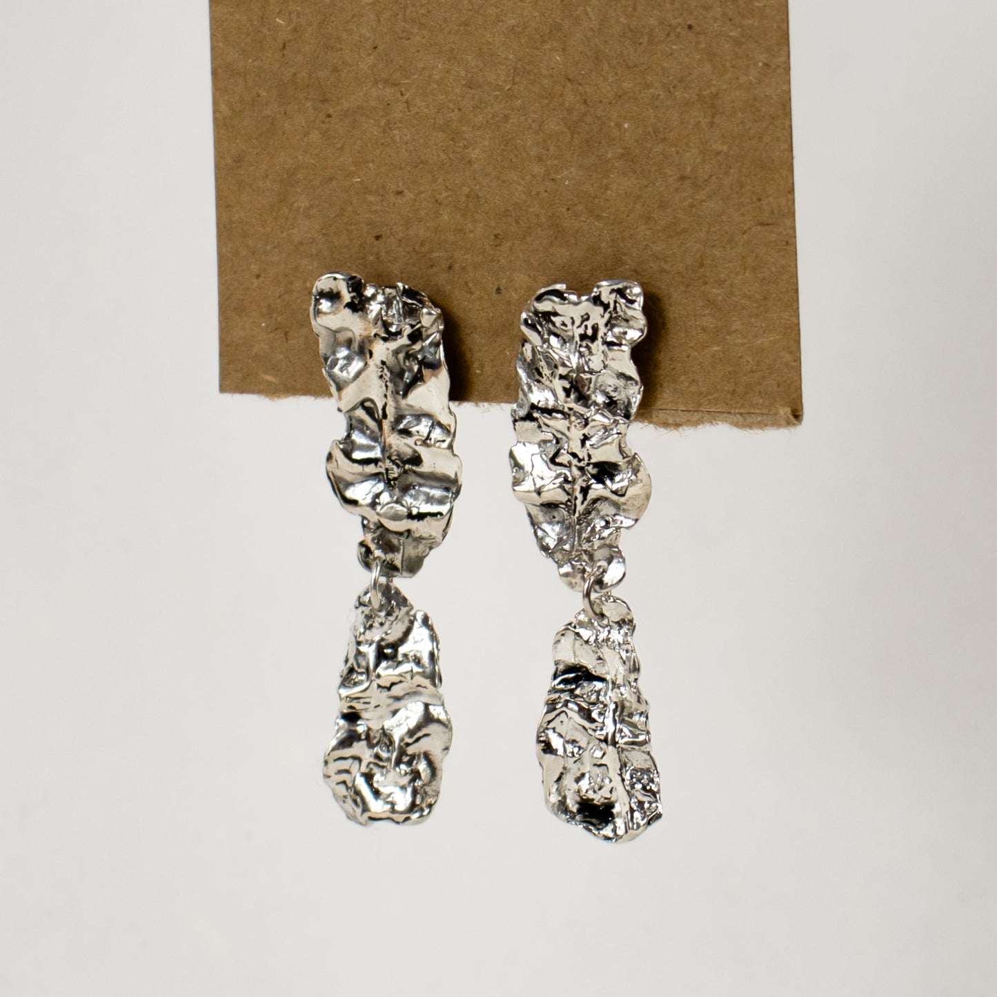 Reclaimed sterling silver double-wave seaweed stud earrings measuring 2 inches in length handmade and finished in our Catskills store-studio.