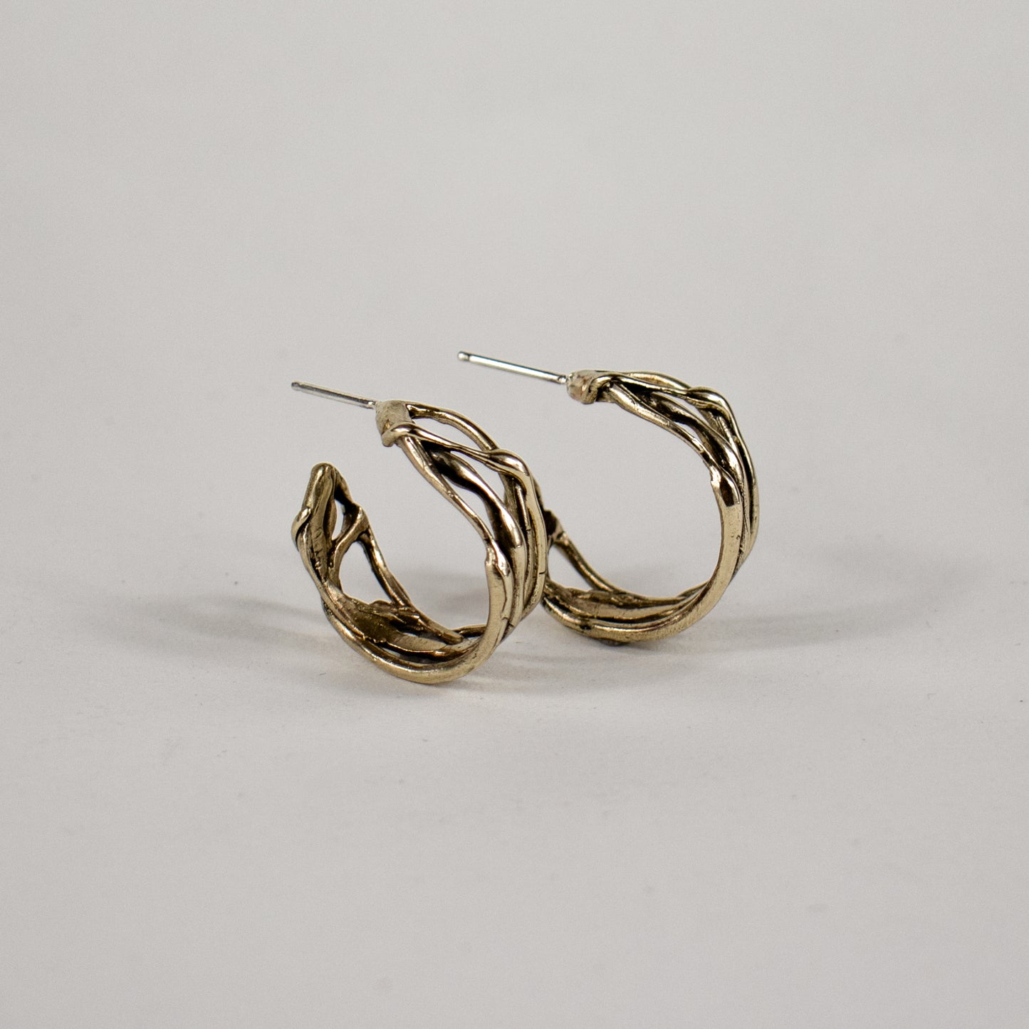 Melted wave hoop earrings available in all sterling silver or brass with sterling post and backings measuring 0.25 inch wide and 0.75 inch in diameter handmade and finished in our Catskills store-studio.