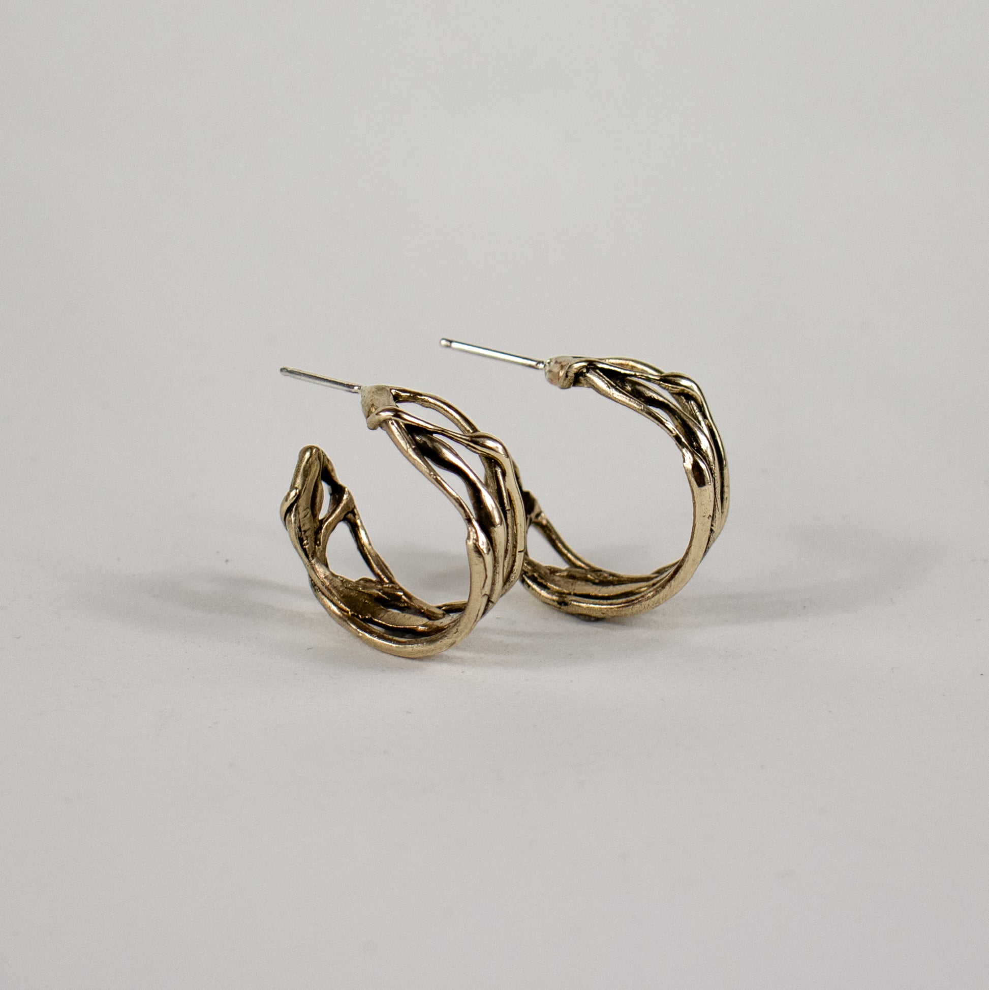 Melted wave hoop earrings available in all sterling silver or brass with sterling post and backings measuring 0.25 inch wide and 0.75 inch in diameter handmade and finished in our Catskills store-studio.
