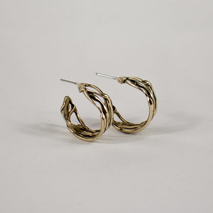 Melted wave hoop earrings available in all sterling silver or brass with sterling post and backings measuring 0.25 inch wide and 0.75 inch in diameter handmade and finished in our Catskills store-studio.