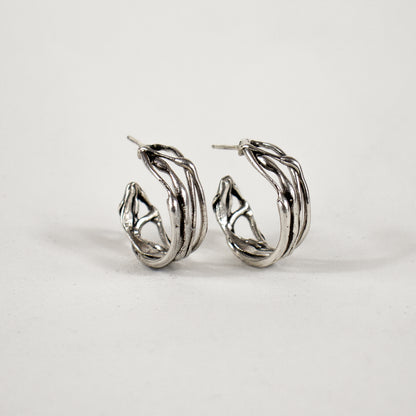 Melted wave hoop earrings available in all sterling silver or brass with sterling post and backings measuring 0.25 inch wide and 0.75 inch in diameter handmade and finished in our Catskills store-studio.