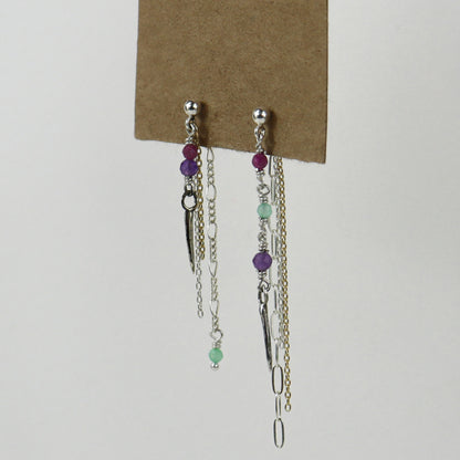 Sterling silver and gold-filled double mixed-chain tassels 2 inches at their longest dangling from sterling studs hand-beaded with ruby, amethyst, and chrysoprase and finished with tiny sterling and brass spikes hanging from paper tag on white background.