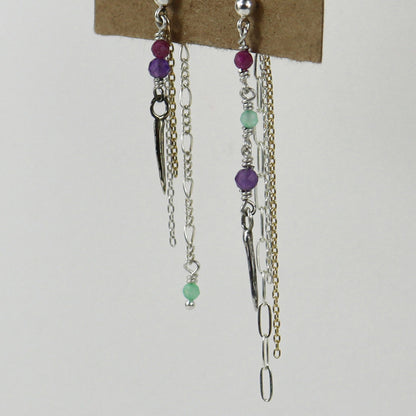 Sterling silver and gold-filled double mixed-chain tassels 2 inches at their longest dangling from sterling studs hand-beaded with ruby, amethyst, and chrysoprase and finished with tiny sterling and brass spikes hanging from paper tag on white background.