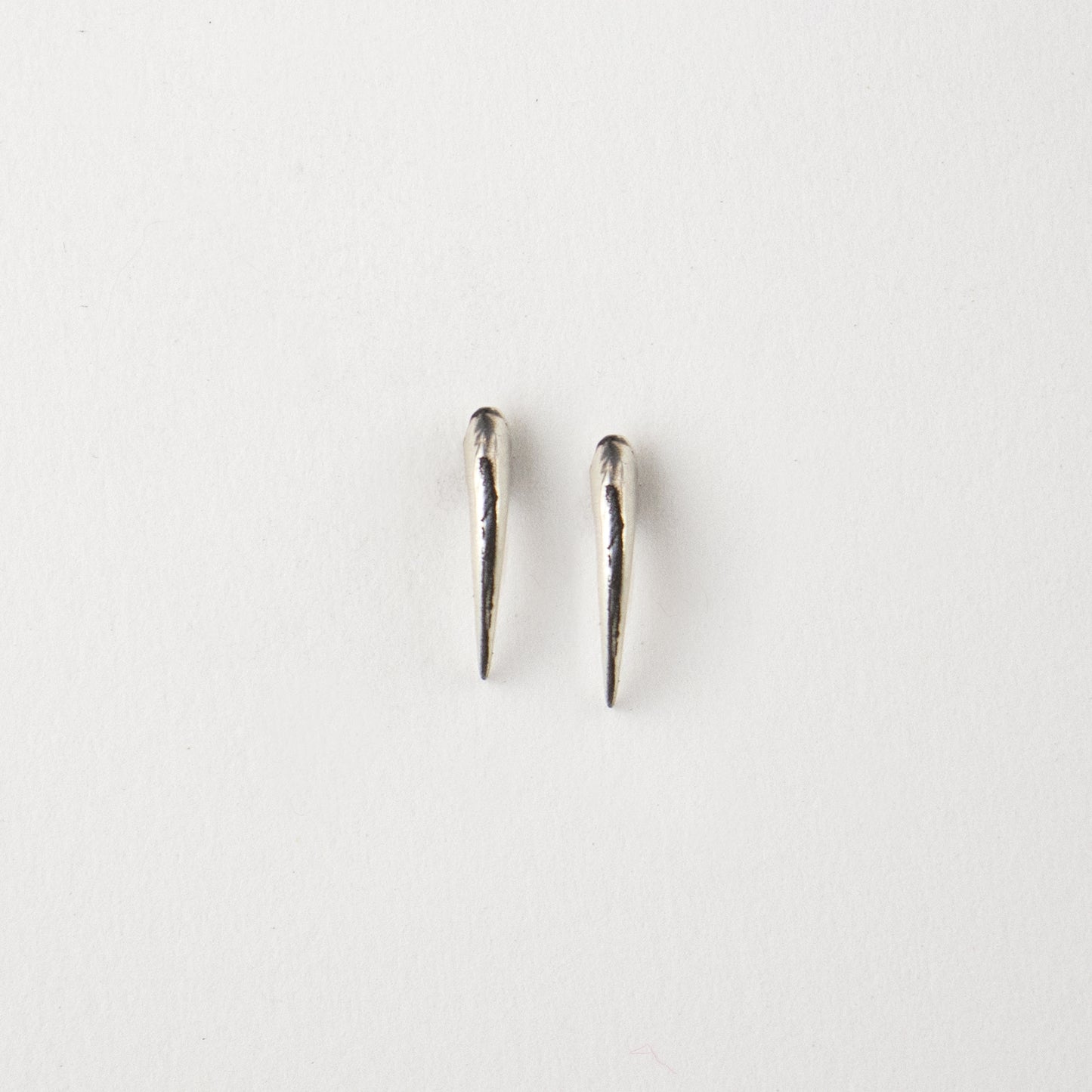 Solid sterling silver Icelandic owl claw stud earrings on white background
